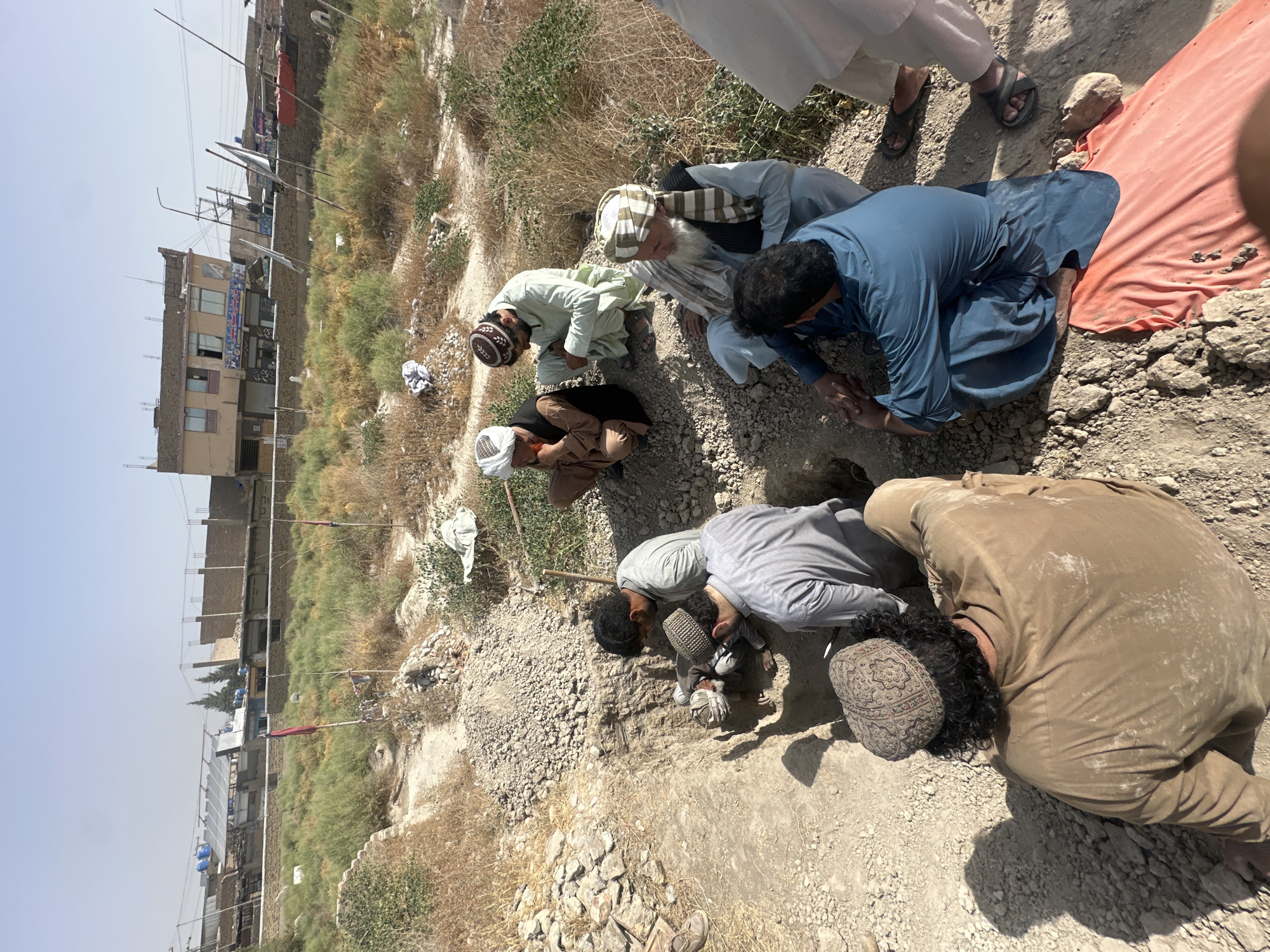 Grave being dug in dry terrain, Quetta, Pakistan