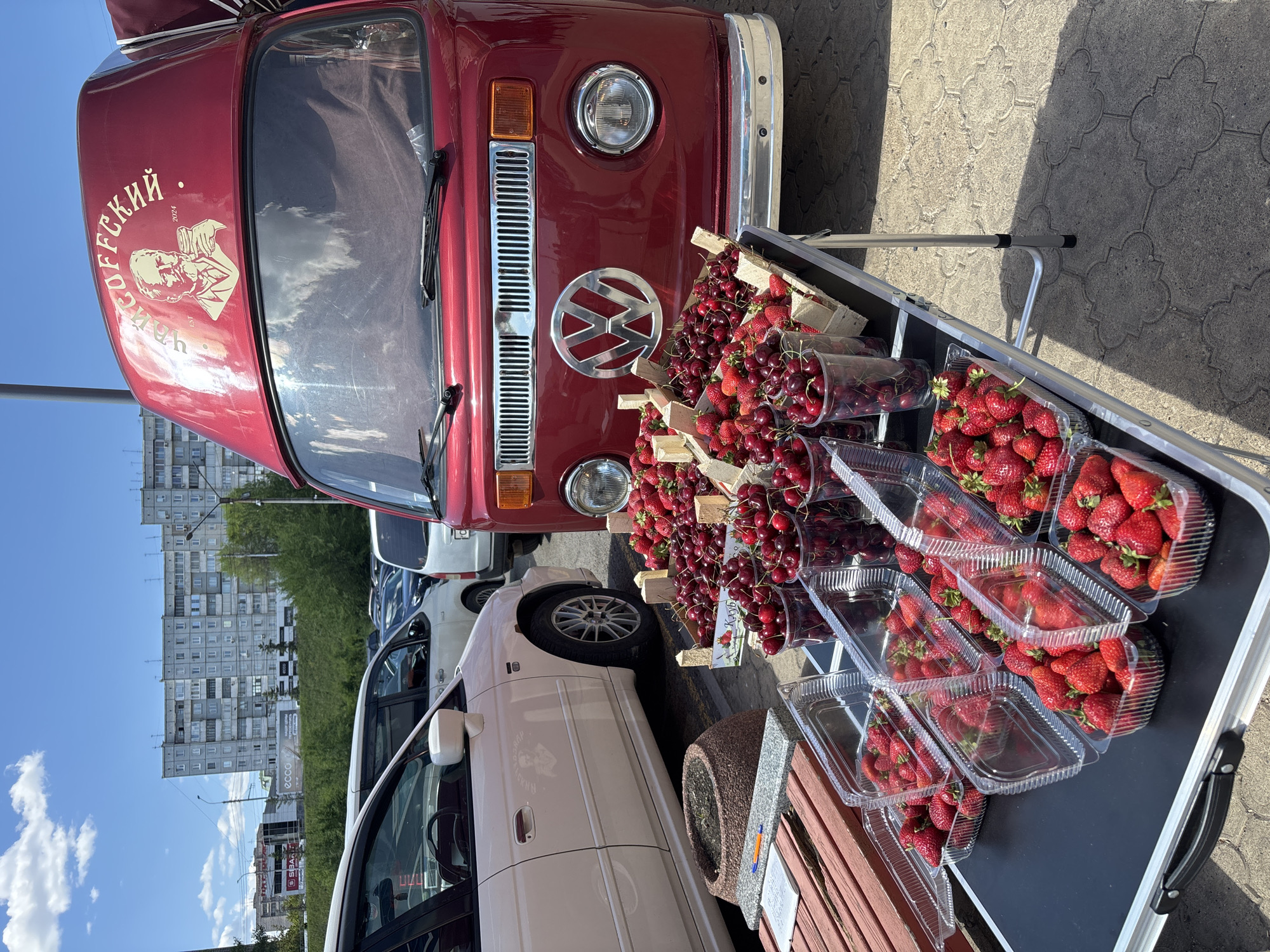 Morning fruit vendor sells berries in Krasnoyarsk street market