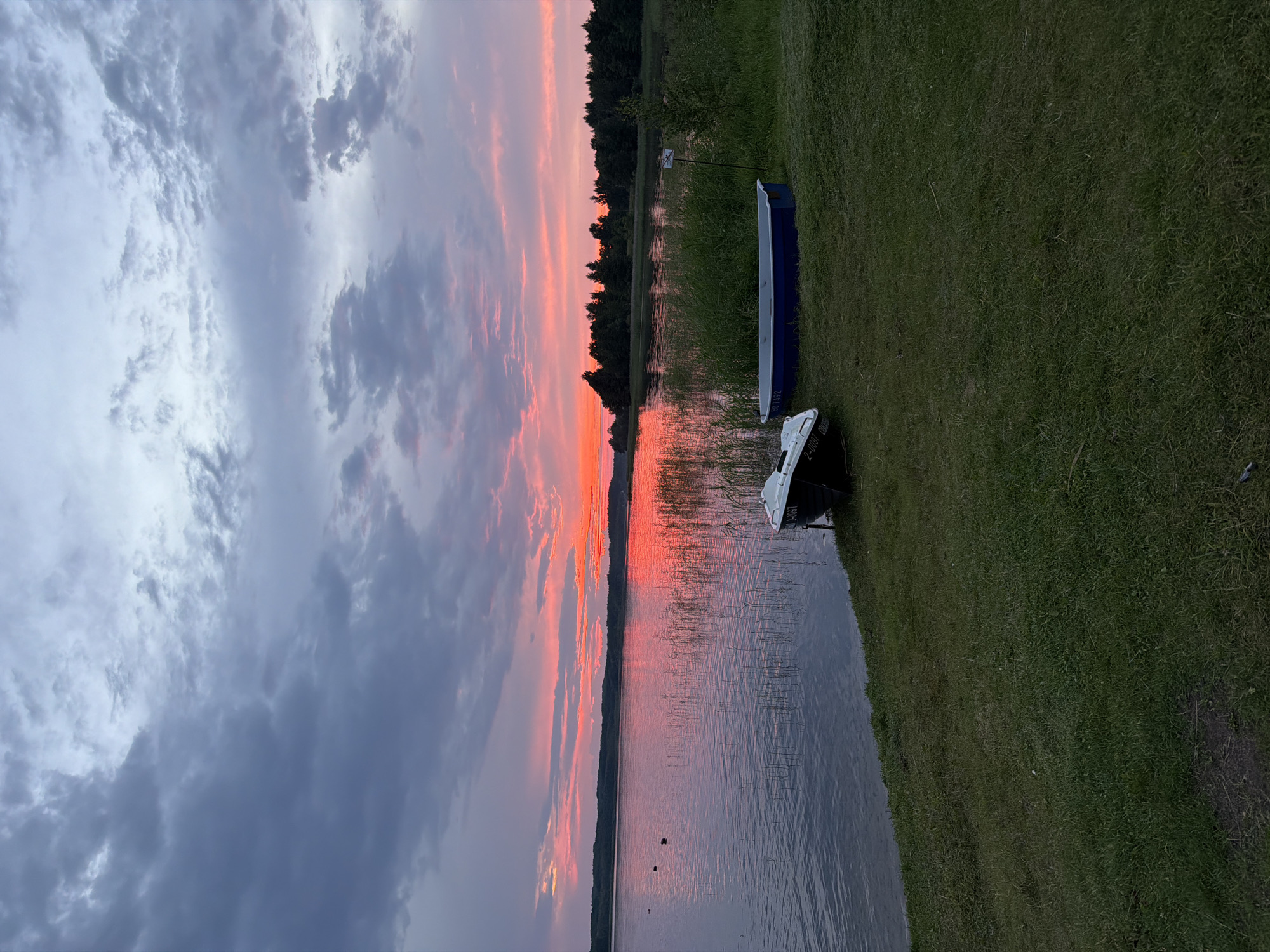 Lake reflects a vivid sunset sky across three angles