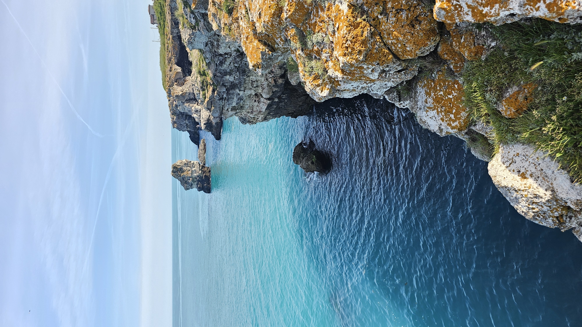 Visitor explores dramatic Tyulenovo coastline during afternoon Black Sea outing
