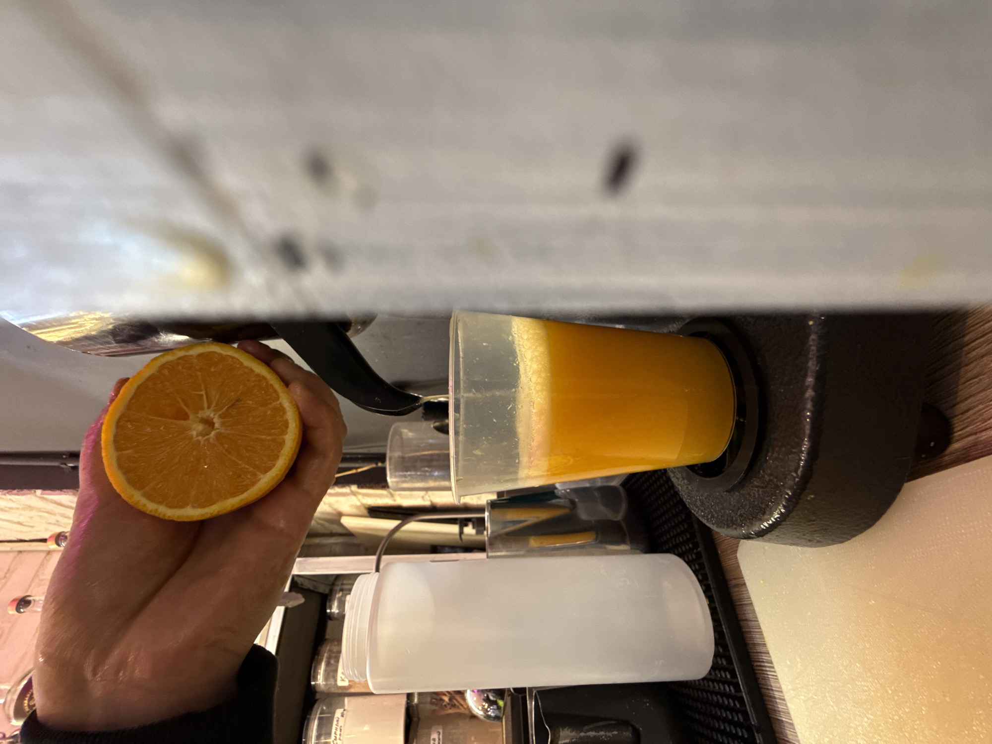 Fresh orange juice being squeezed into a cup in Moscow
