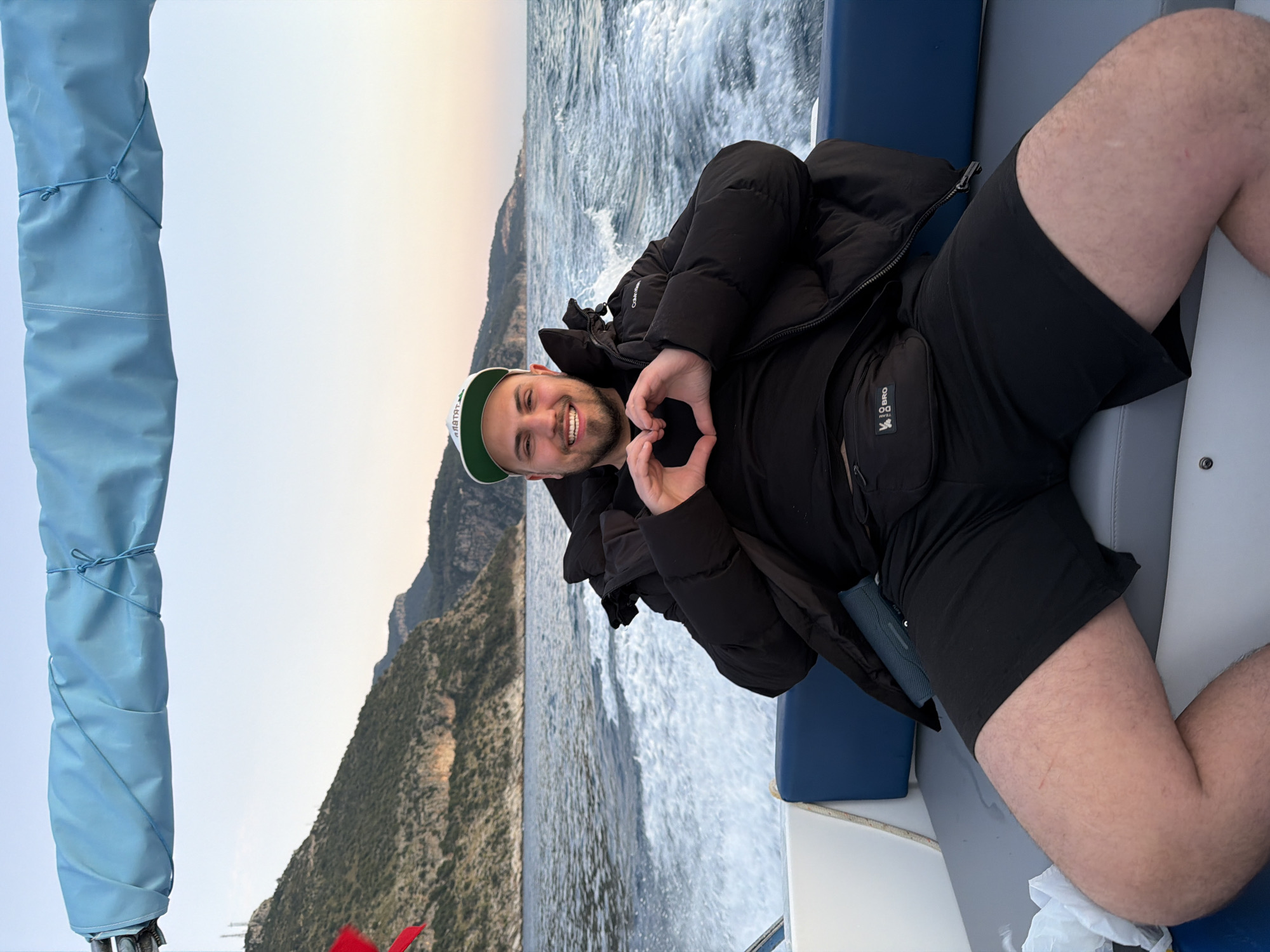 Man Makes Heart Gesture on Boat During Turkish Coast Sunset