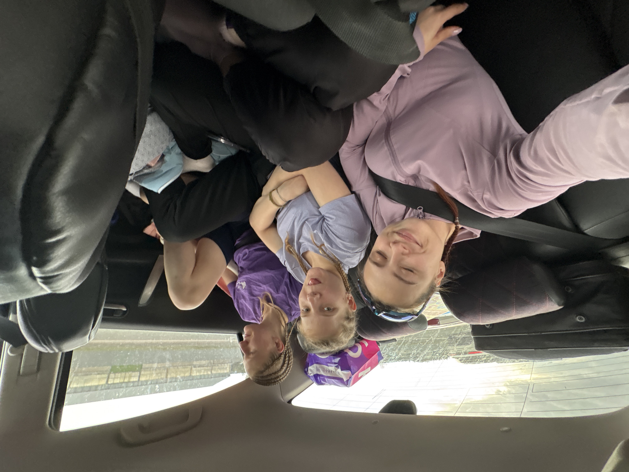 Young women relax in car backseat in Russia