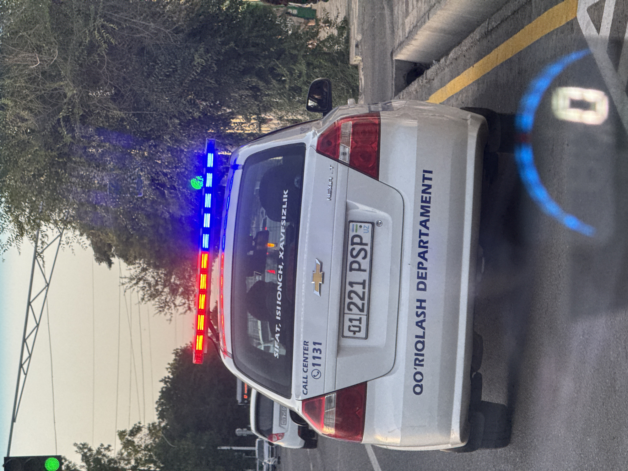 Patrol car spotted at Tashkent intersection during evening traffic