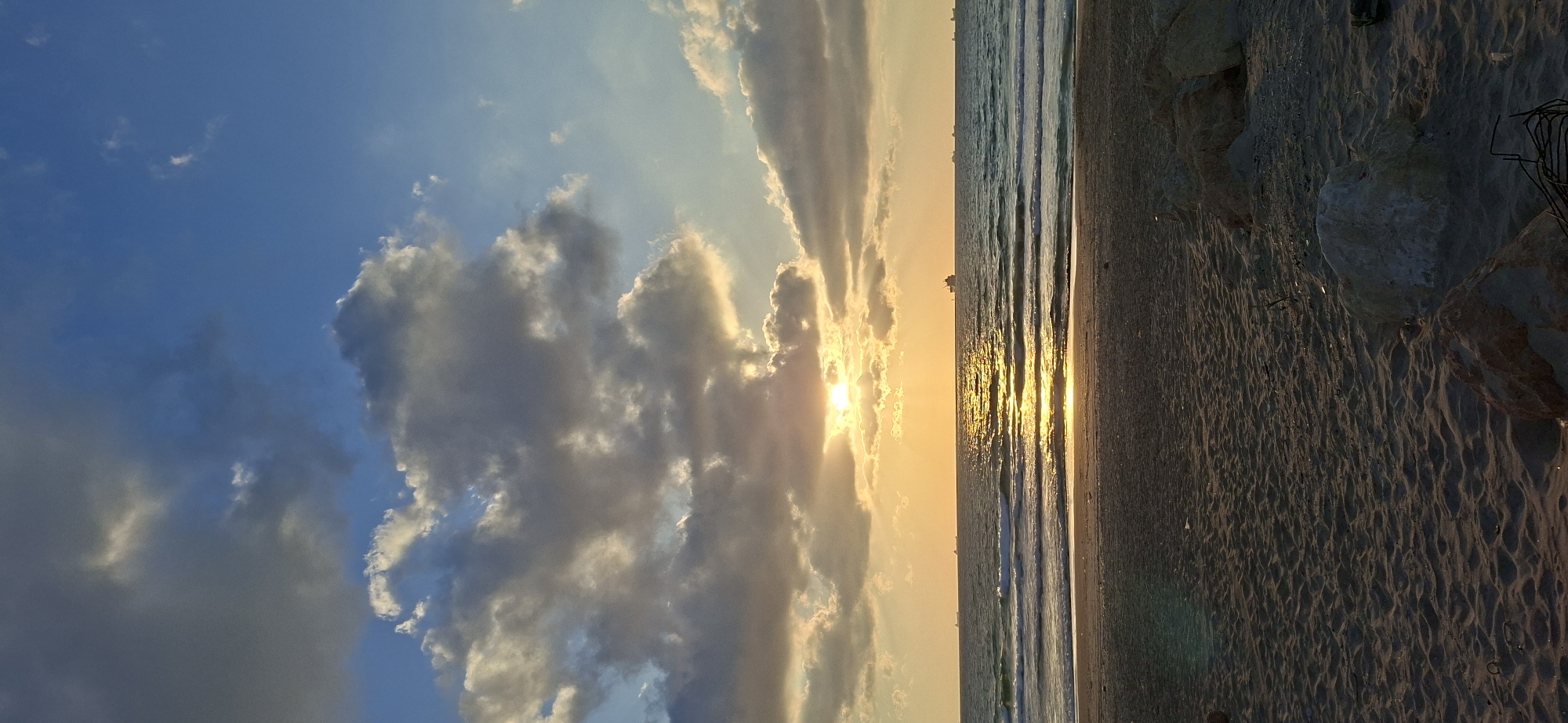 Sunset beach walk: waves, shells, palms, and a sailboat