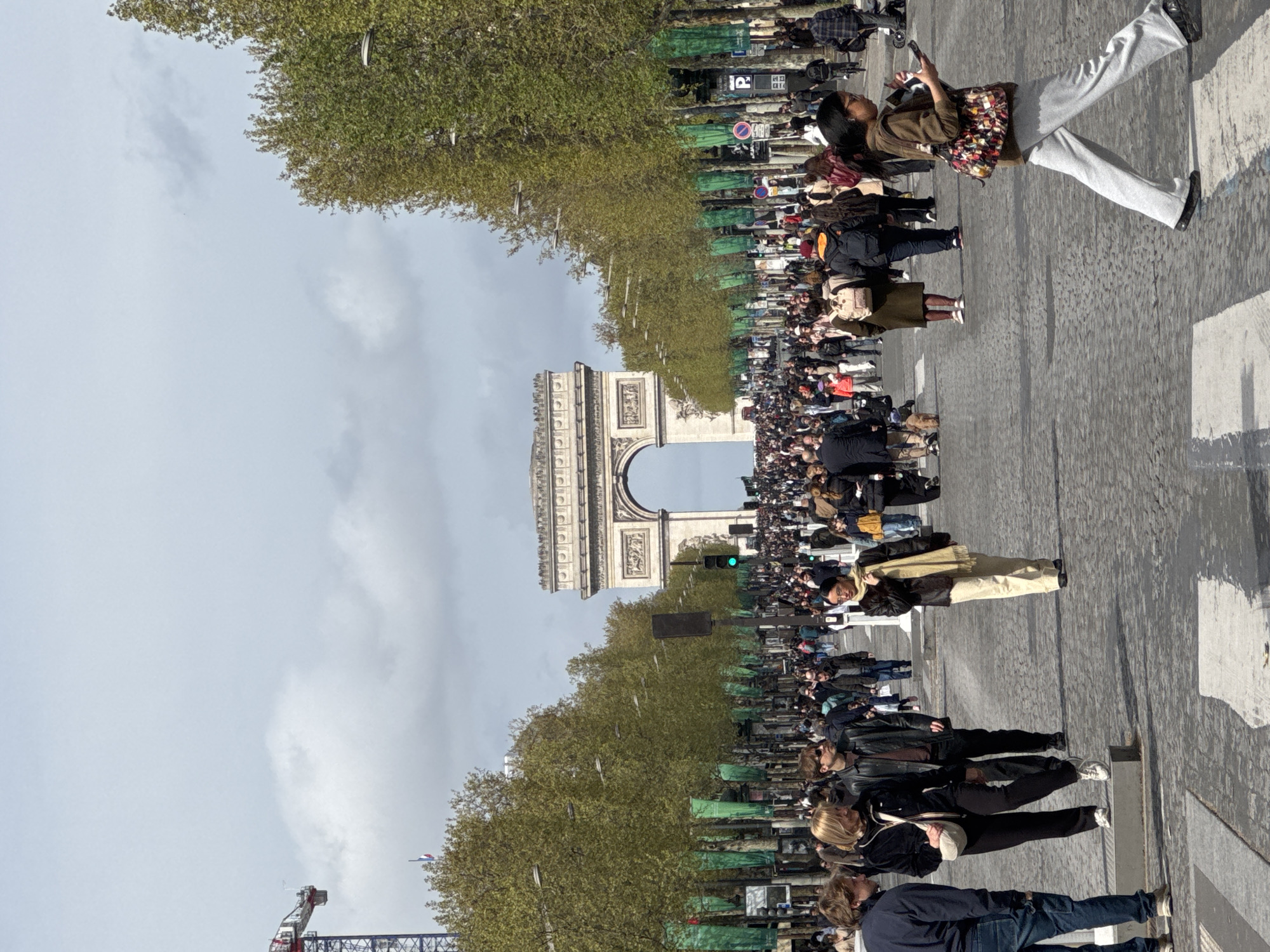 Crowds gather near Arc de Triomphe as cyclist snaps selfie