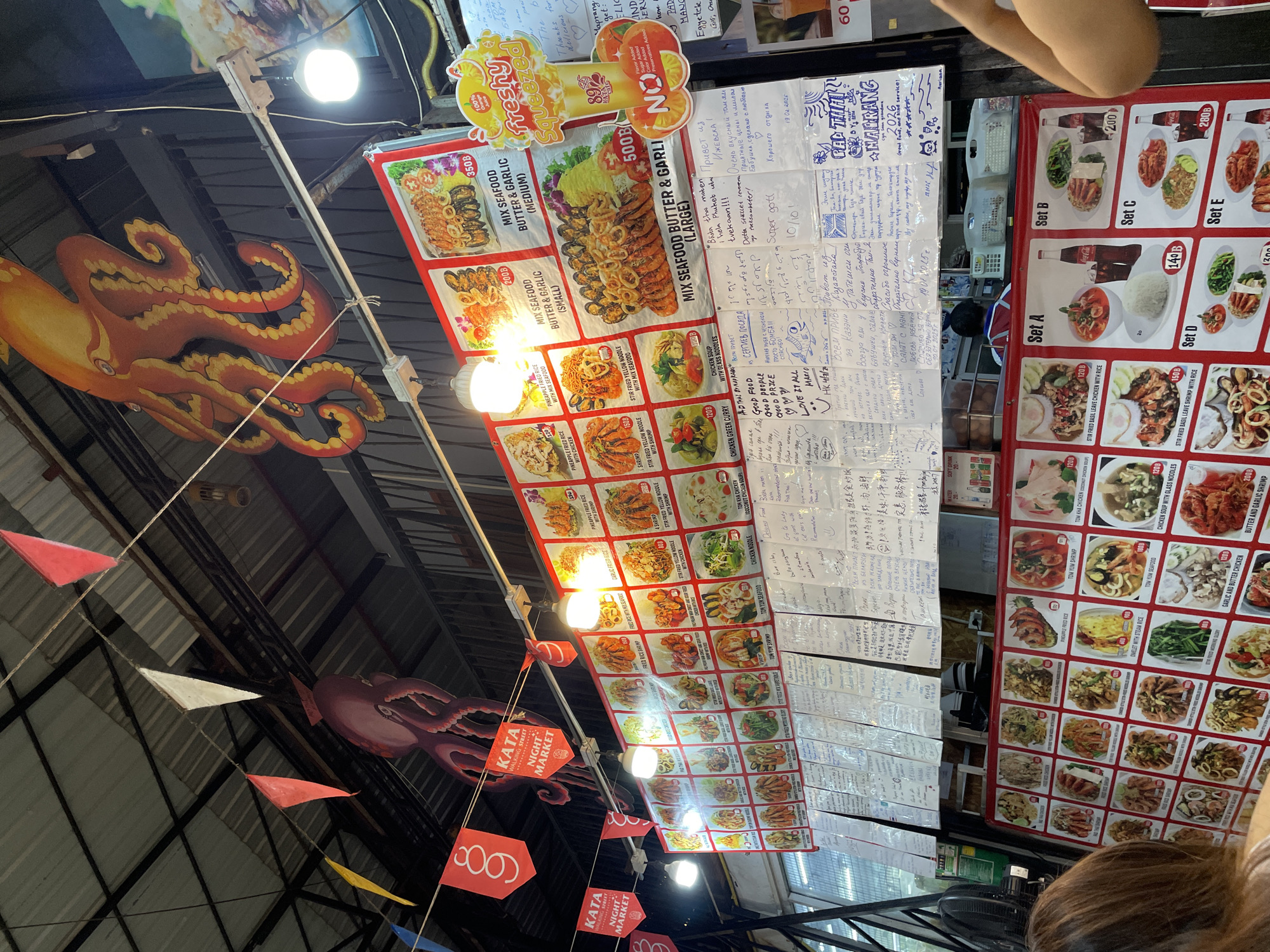 Food vendors serve customers at Kata Night Market, Thailand