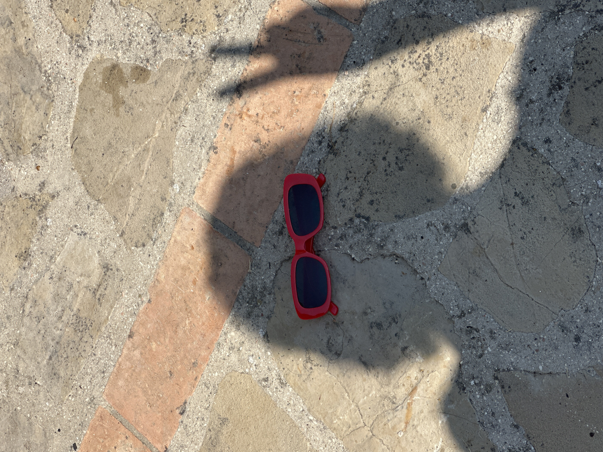 Red-framed sunglasses in the streets of Cannara, Italy