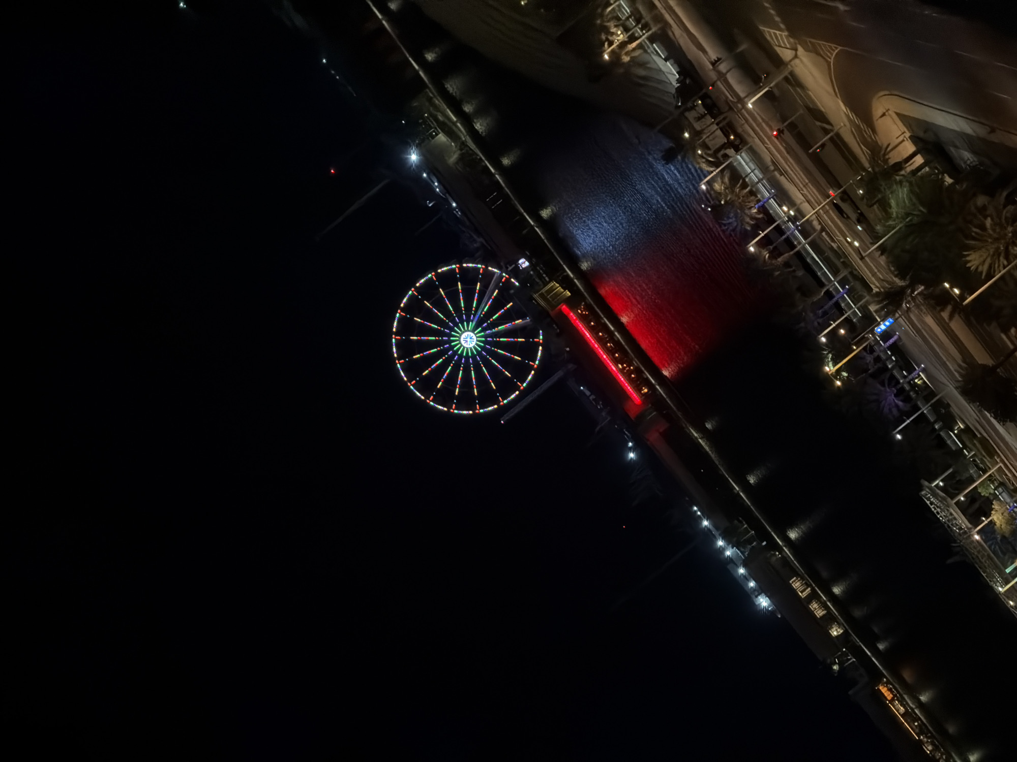 Late-night city views and a waterfront Ferris wheel lit up