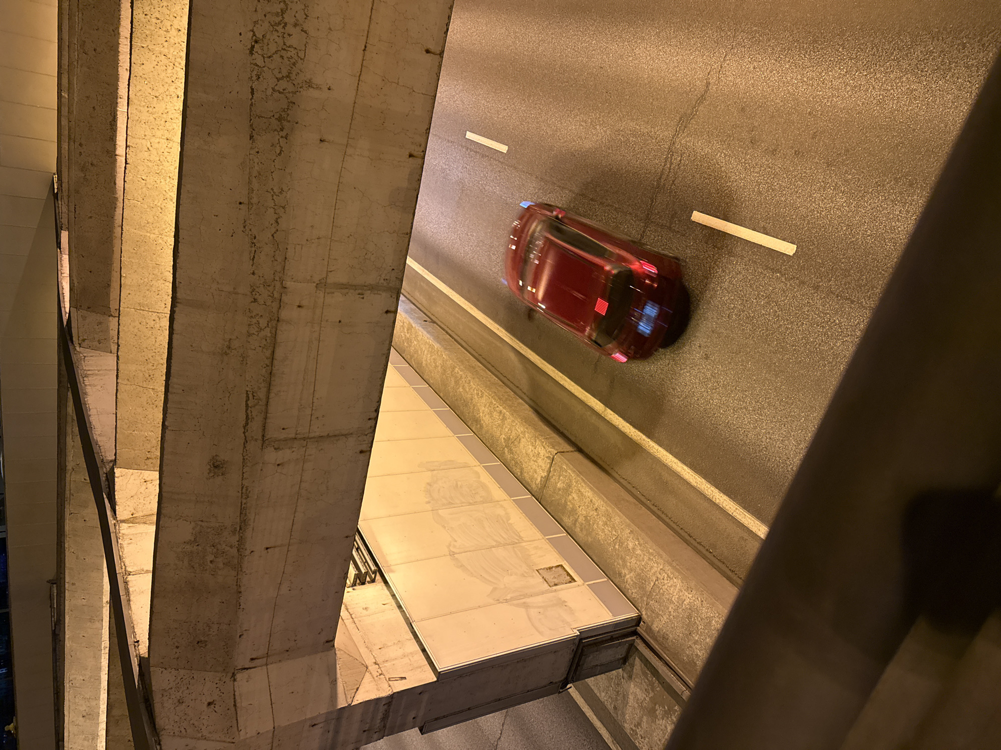 Red car travels on Moscow street from elevated view
