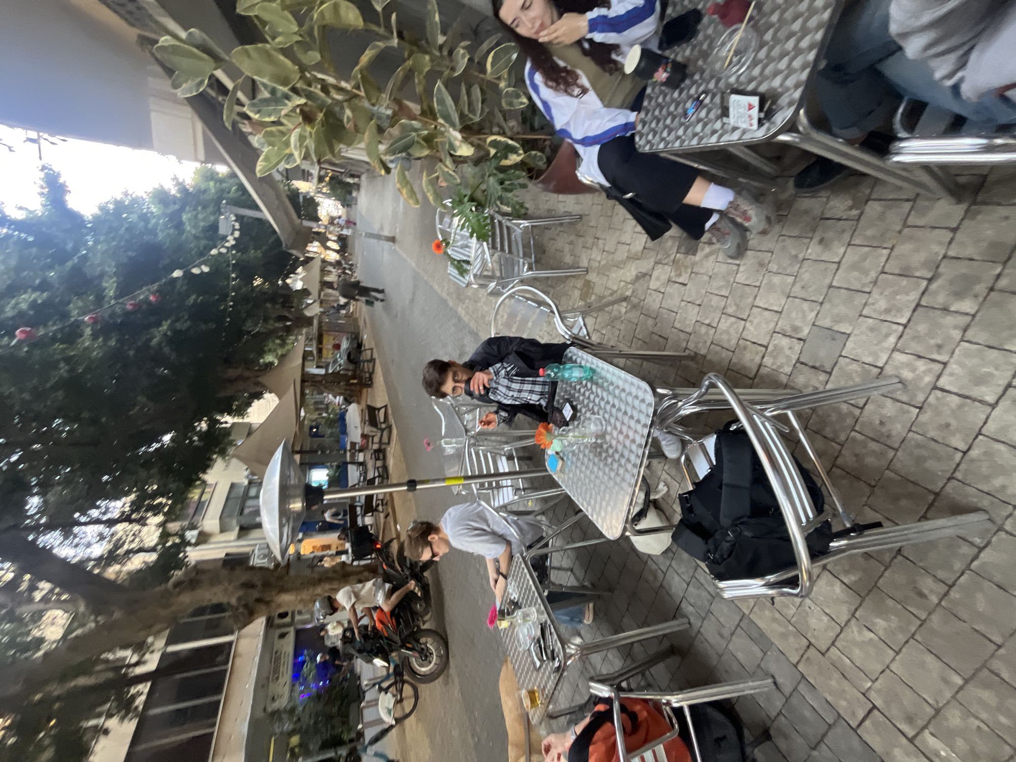 Diners gather at outdoor cafe in Tel Aviv