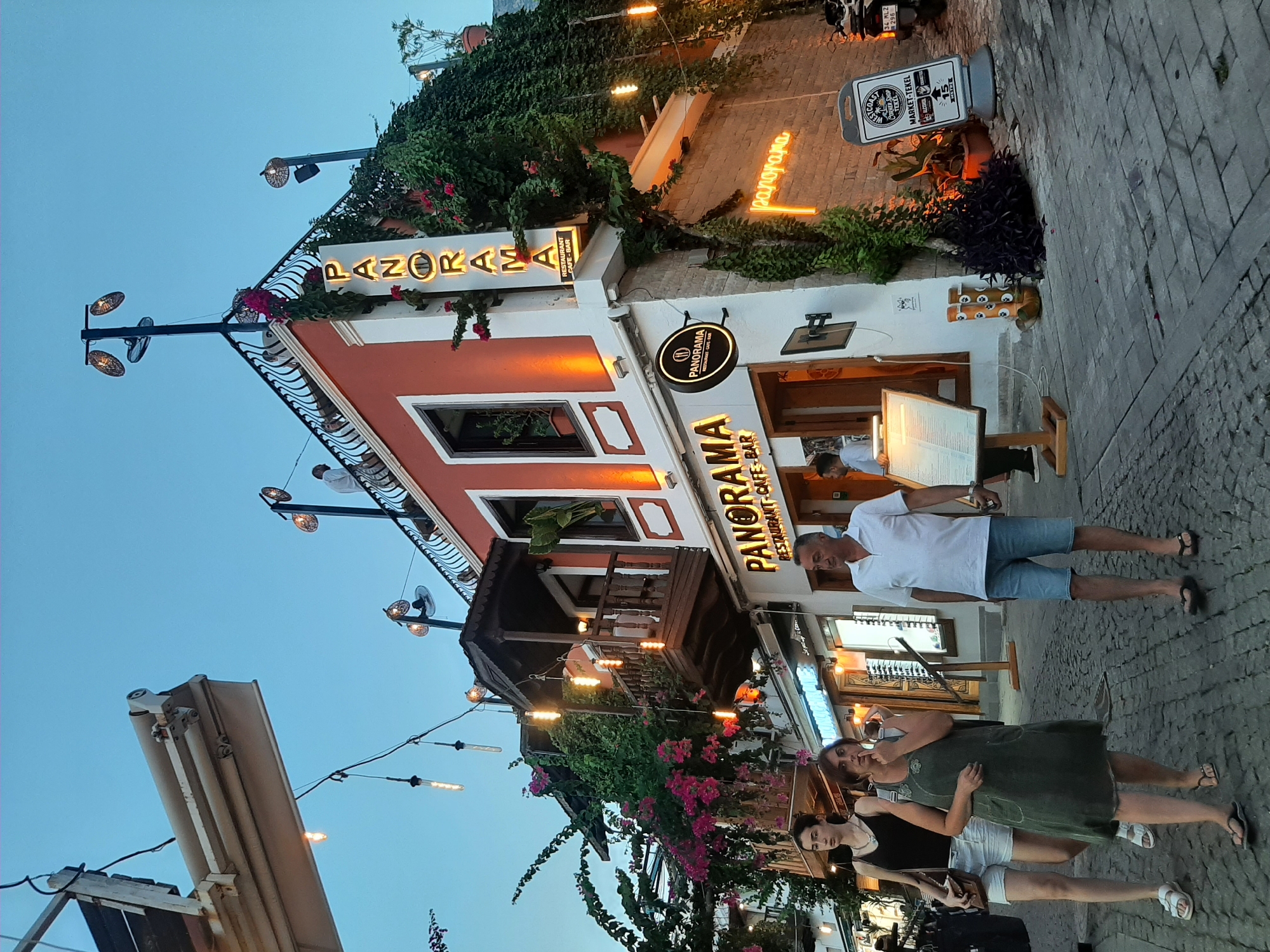Kaş street scene with greenery-draped buildings and decorative lights