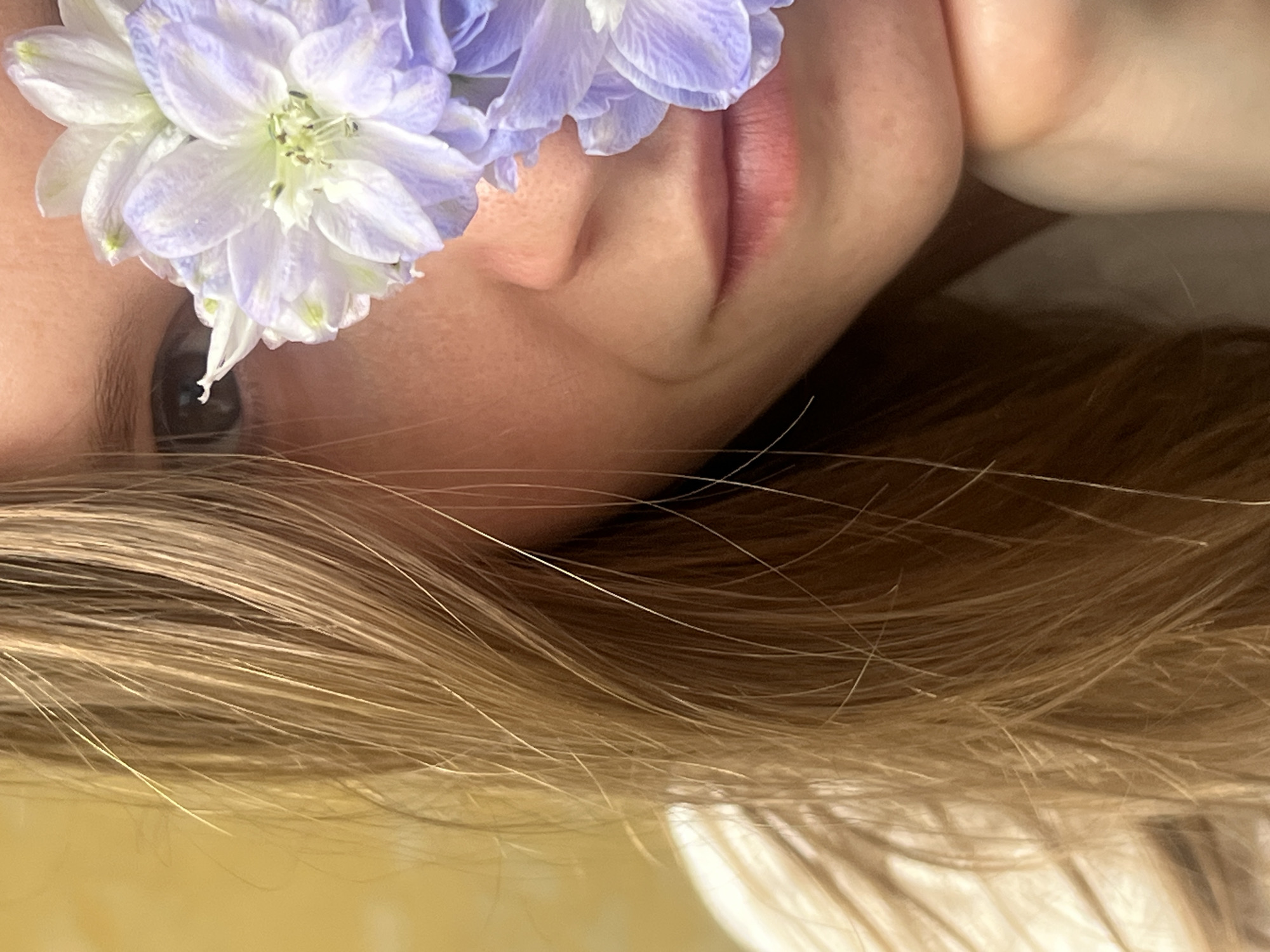 Person photographed with purple flower bouquet in close-up portraits
