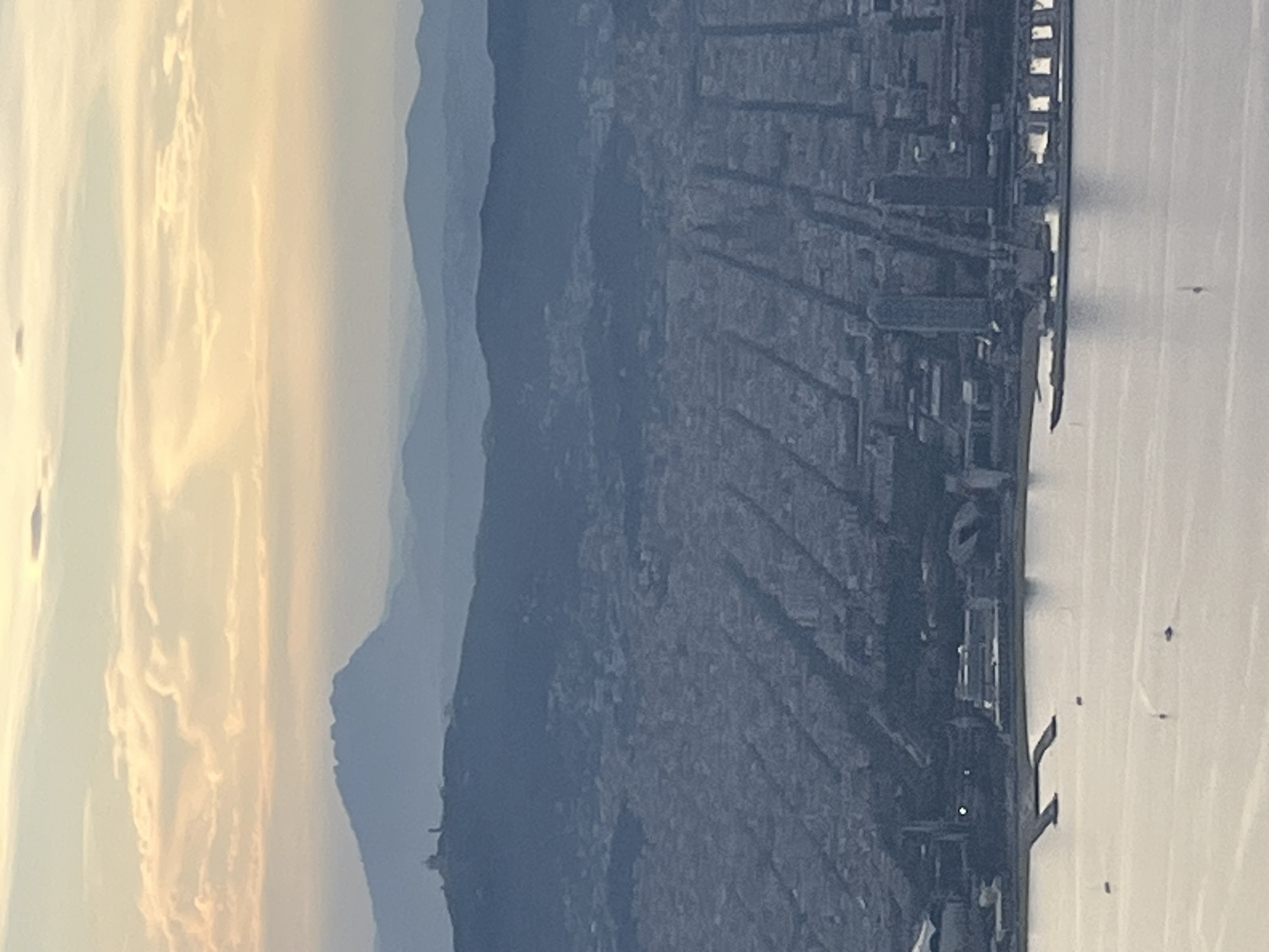 Elevated view captures Barcelona cityscape at dusk from unknown location