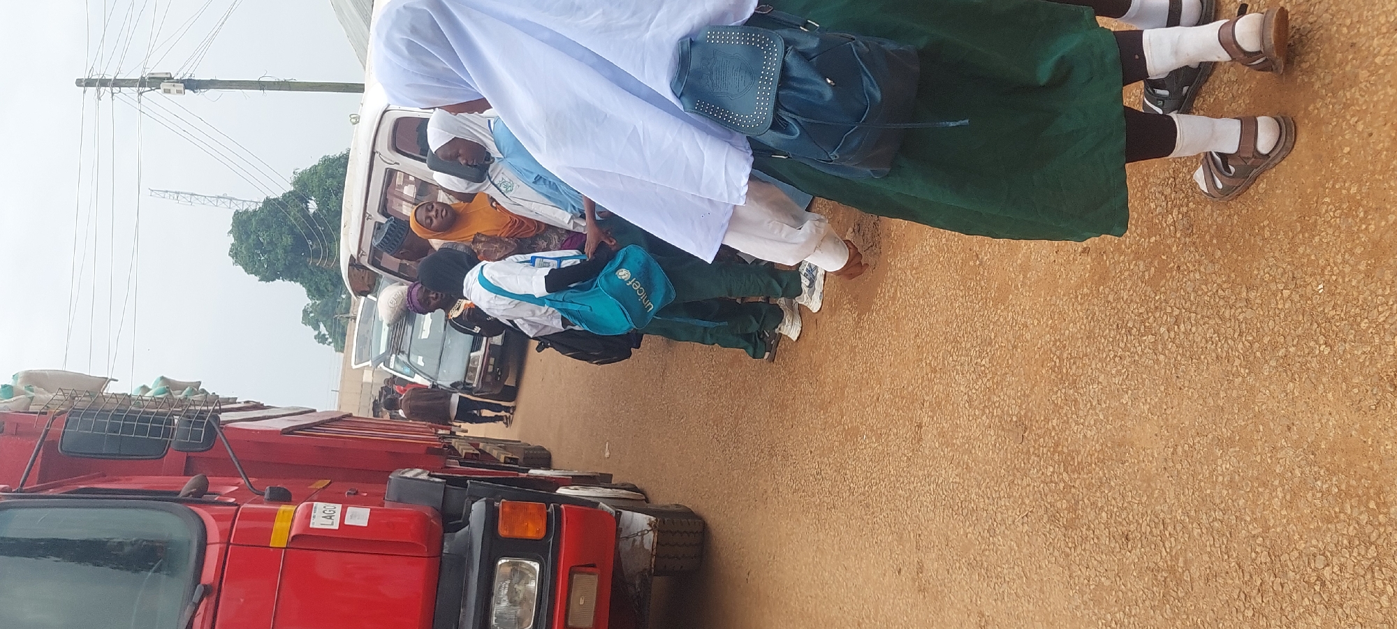 Market day activity around grain truck and street vendors