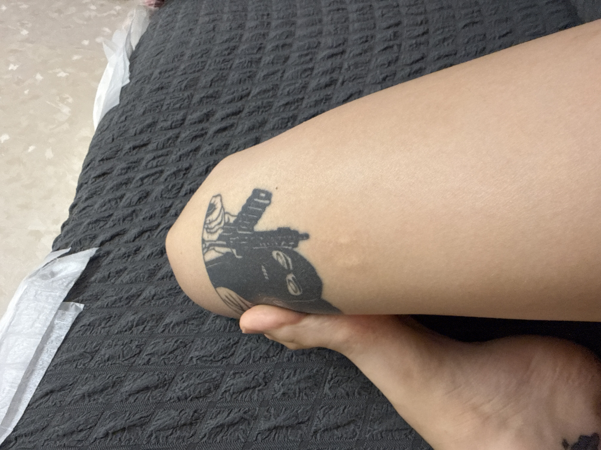 Kyiv apartment downtime: tattoos, toys, and the TV on.