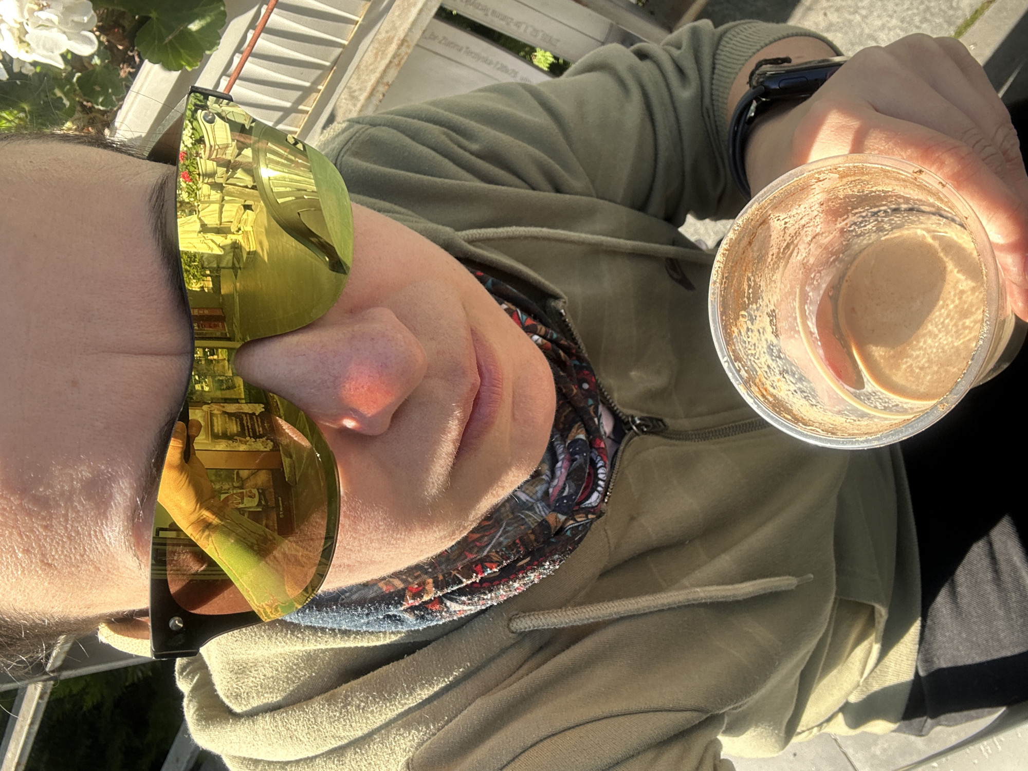 Person enjoys morning beverage outdoors in sunny Sofia