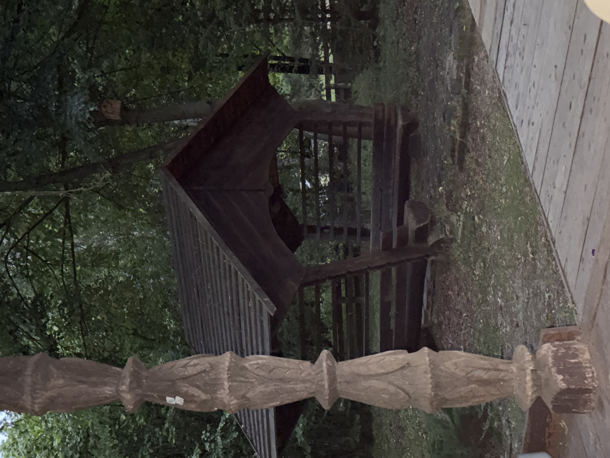 Carved wooden post and forest gazebo in rural Russia