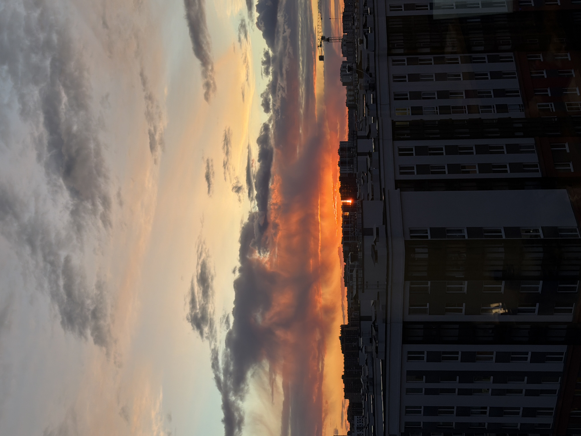 Dramatic sunset illuminates Murino apartment buildings, Russia