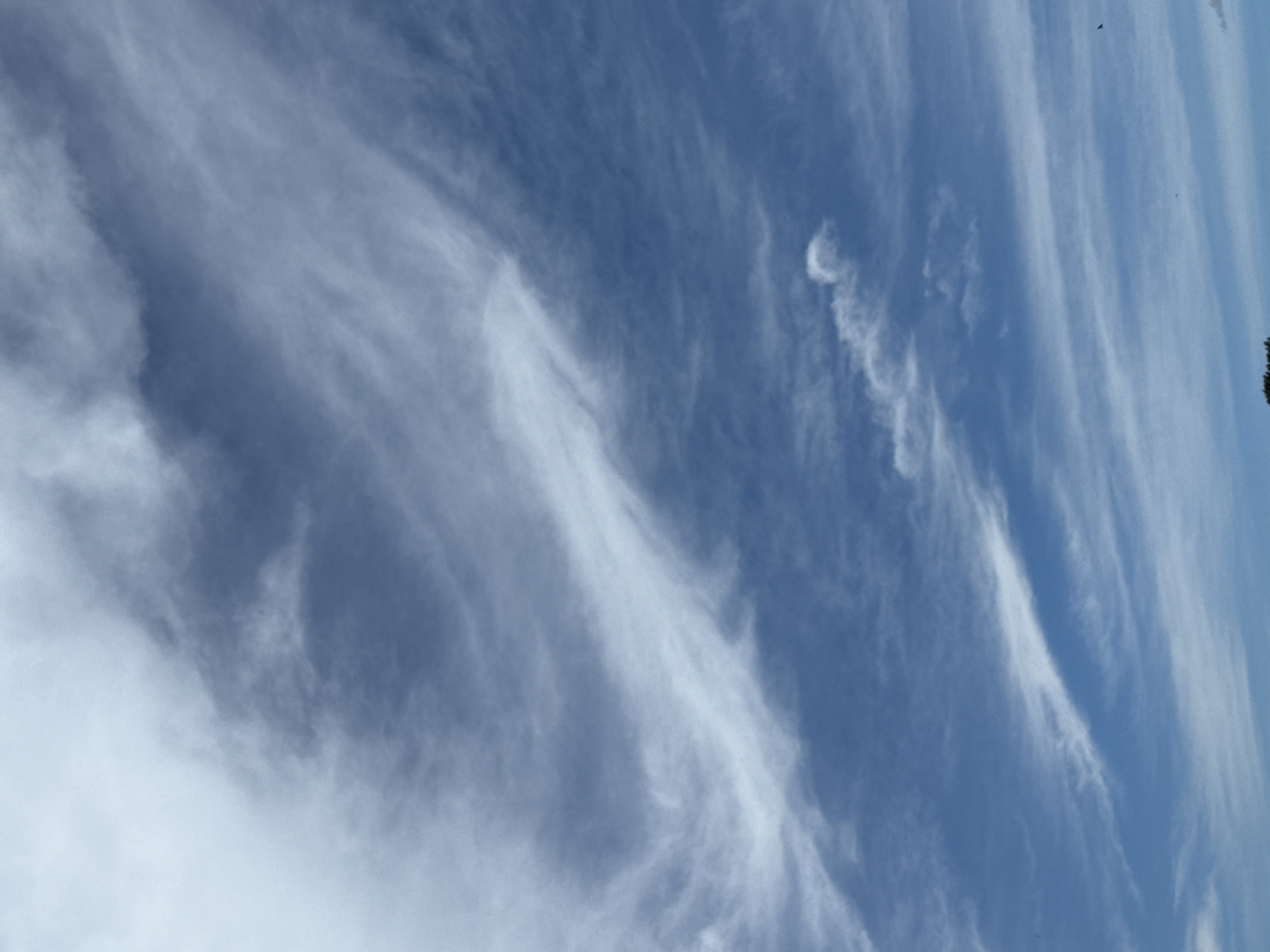 Wide open blue sky with scattered cirrus clouds