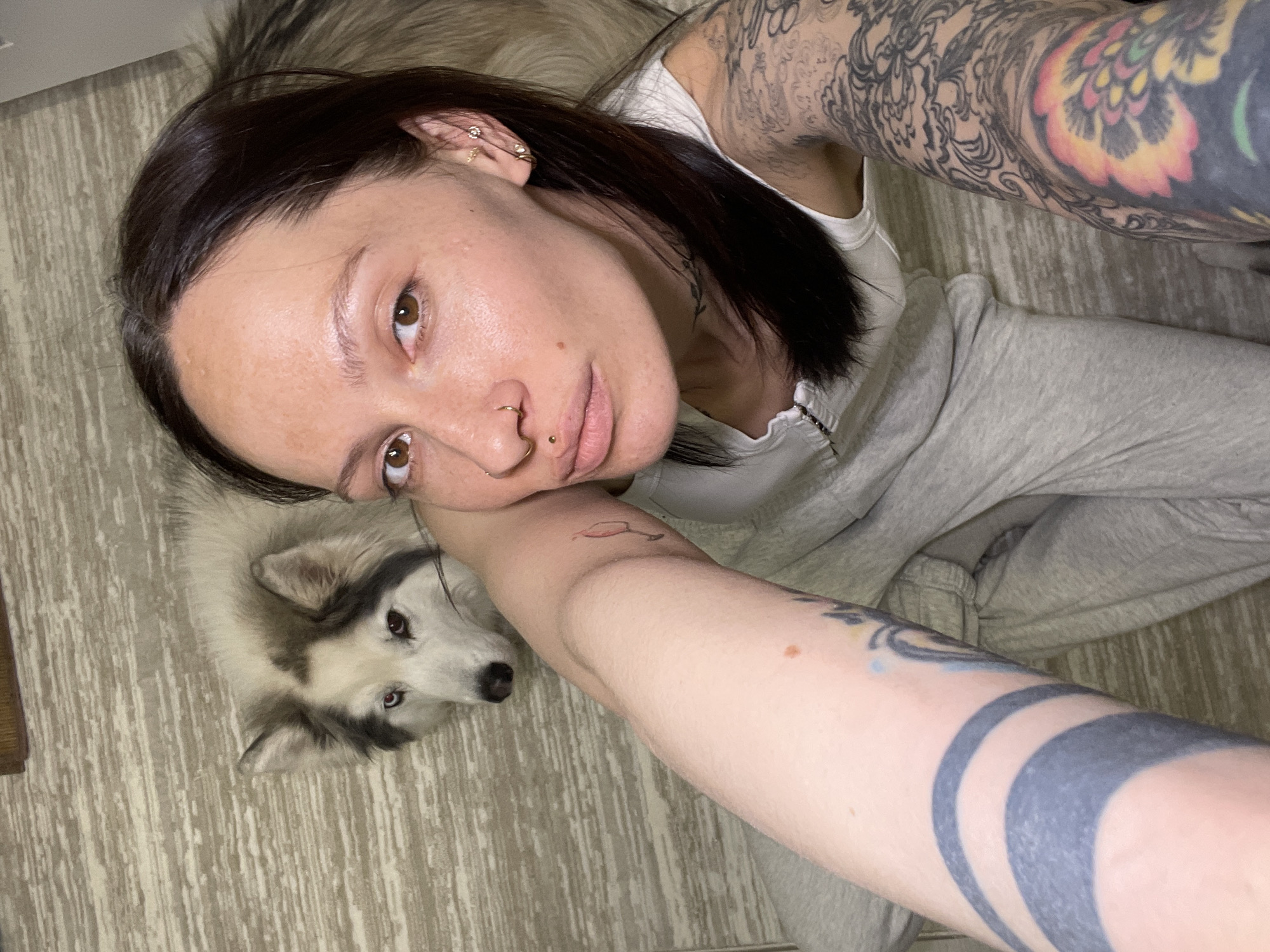 Woman and dog rest together indoors in Izhevsk