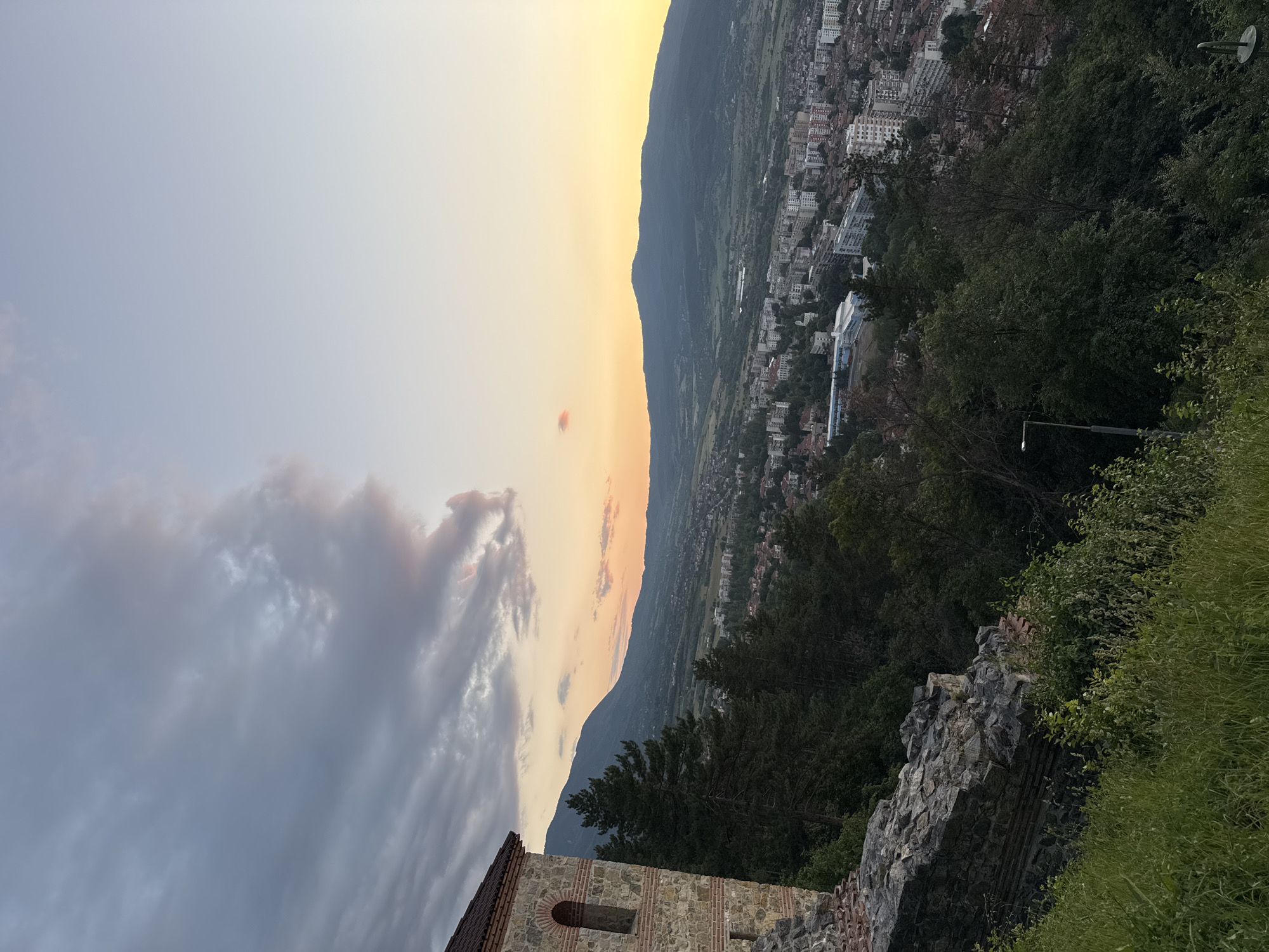 Witness documents urban valley and forest views during evening