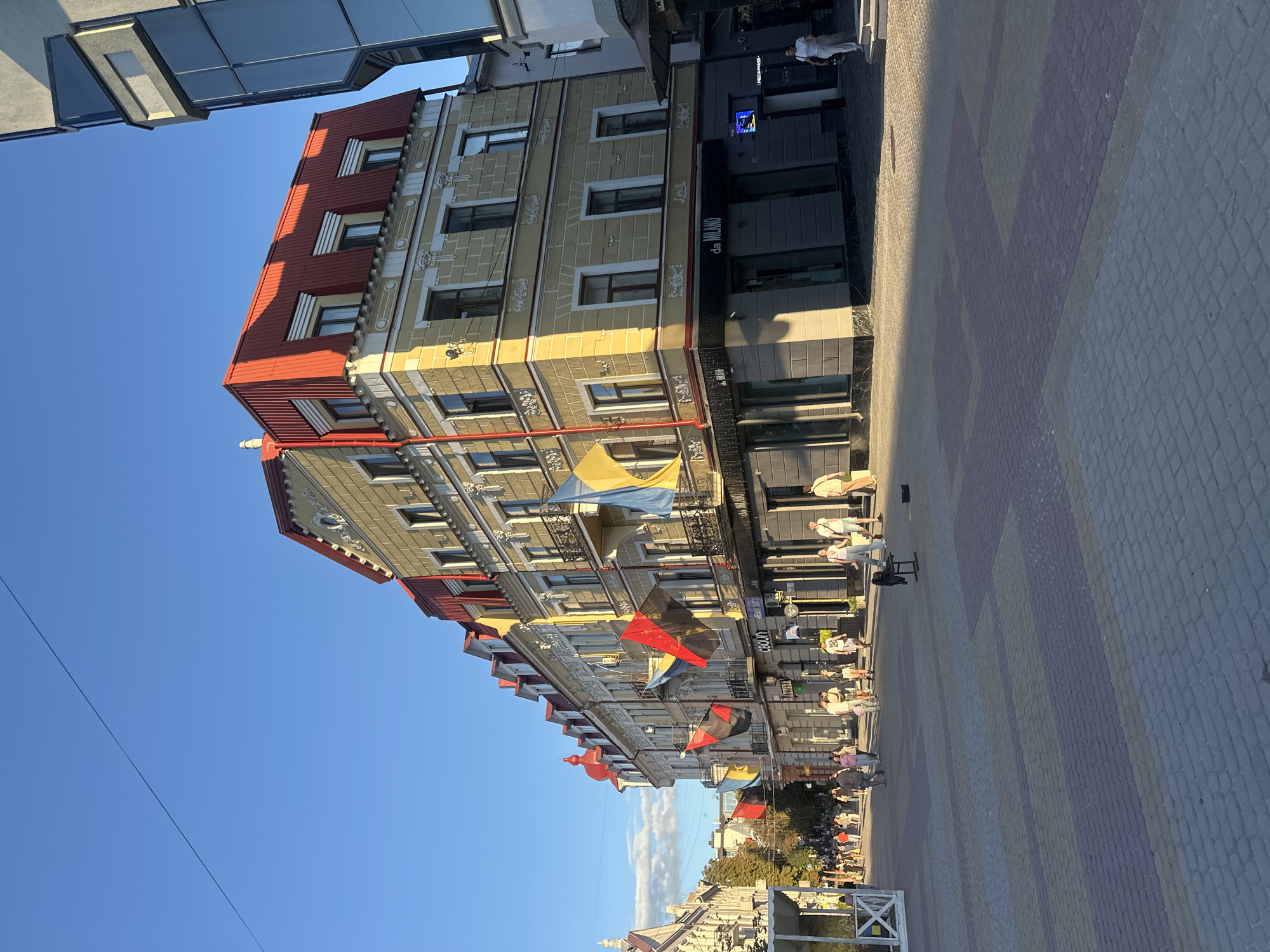 Golden-hour street scene along a cobblestone block in Ternopil