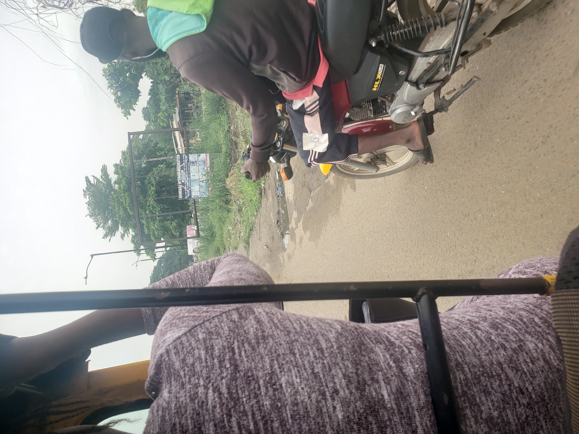 Passenger documents overcast roadside scene from Keke NAPEP in Nigeria