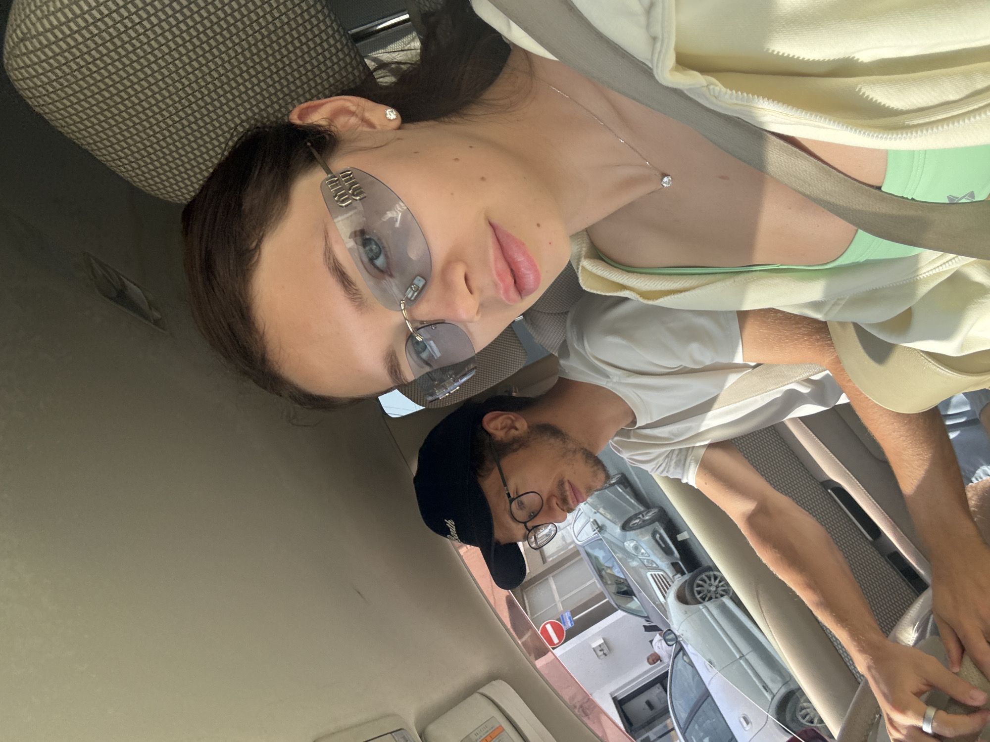 Two people photographed in car during sunny day in Larnaca