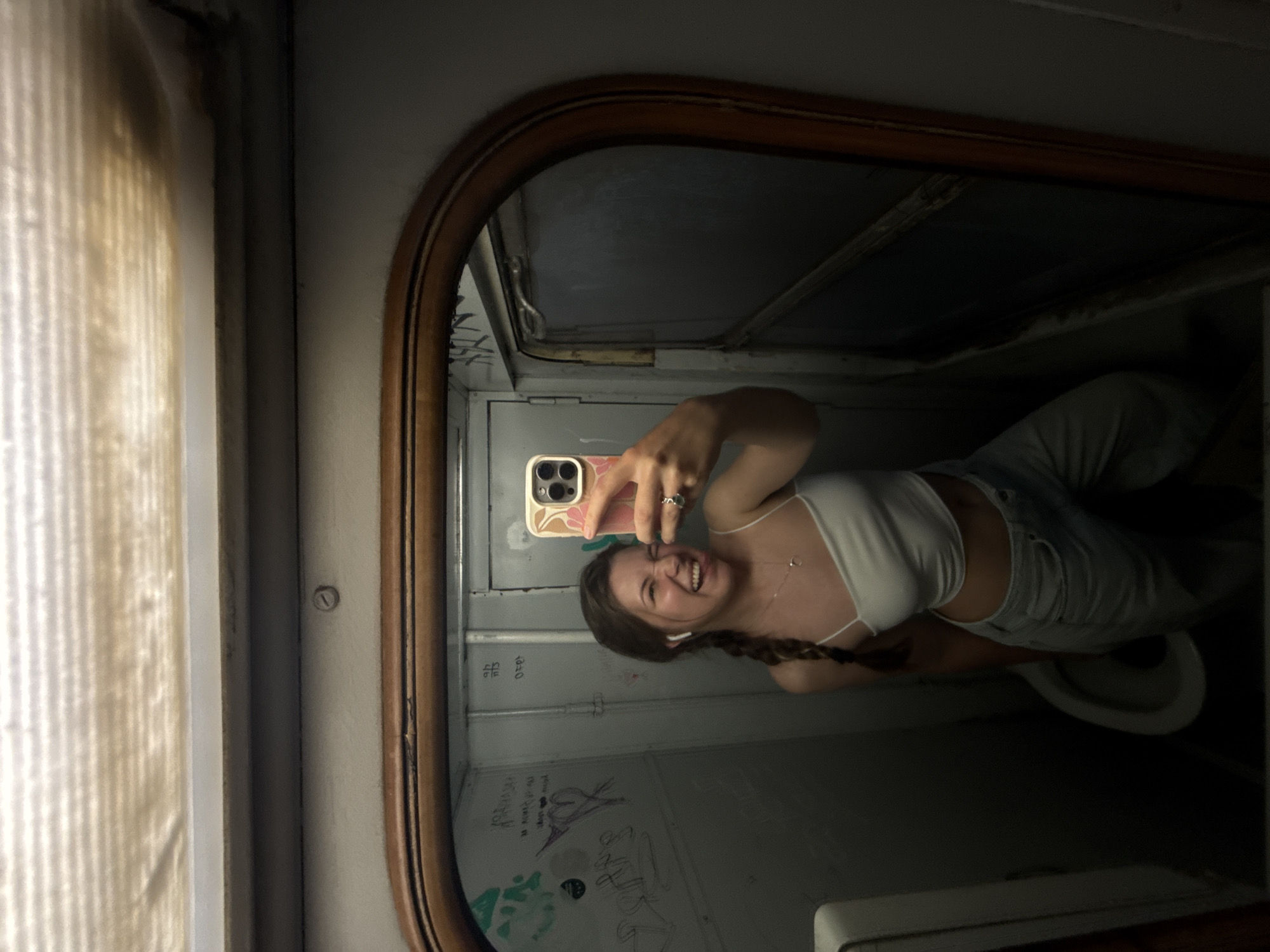 Woman takes mirror selfies in compact space in Serbia