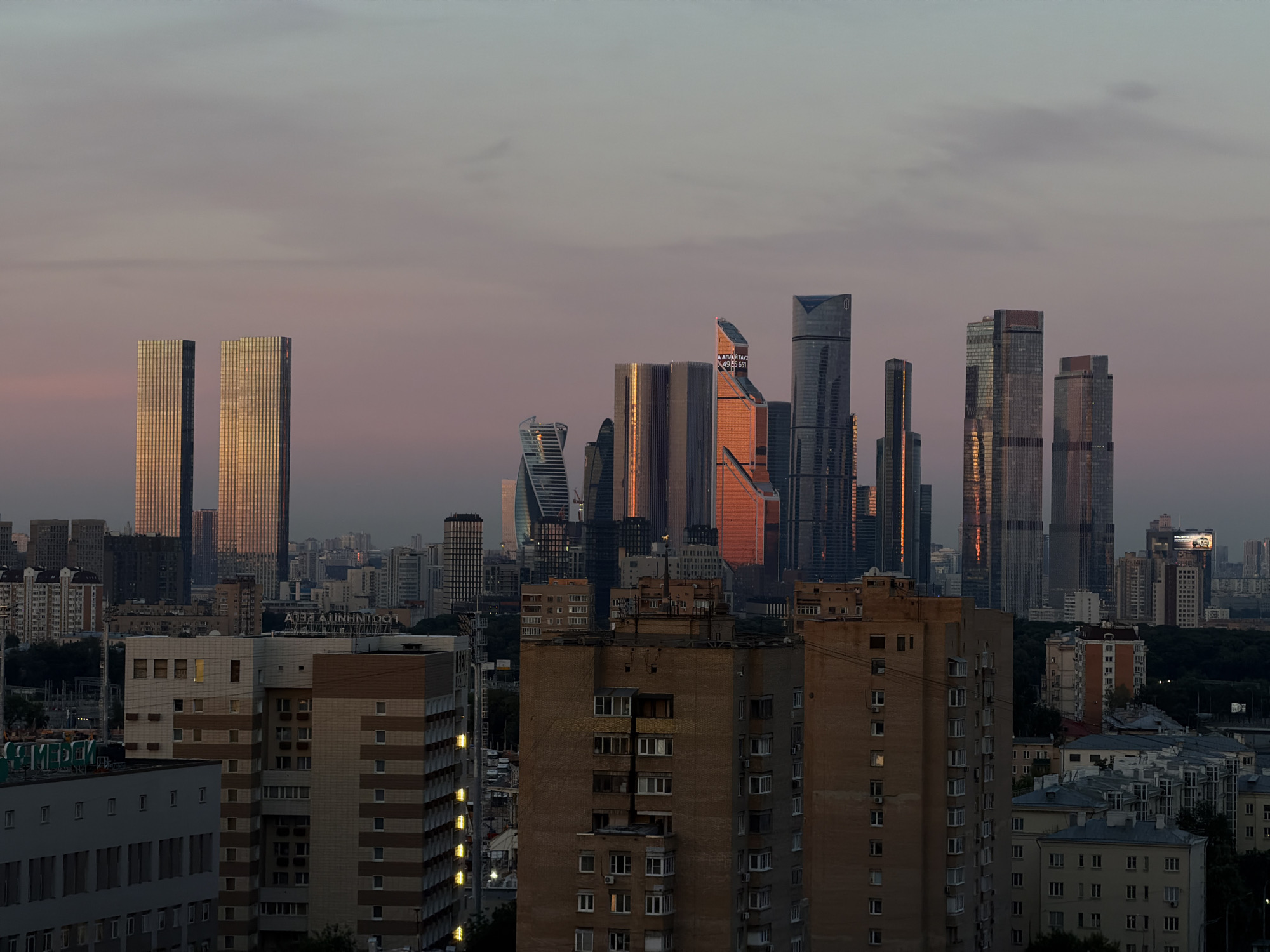 City skyline at sunset, art deco tower and residential sprawl