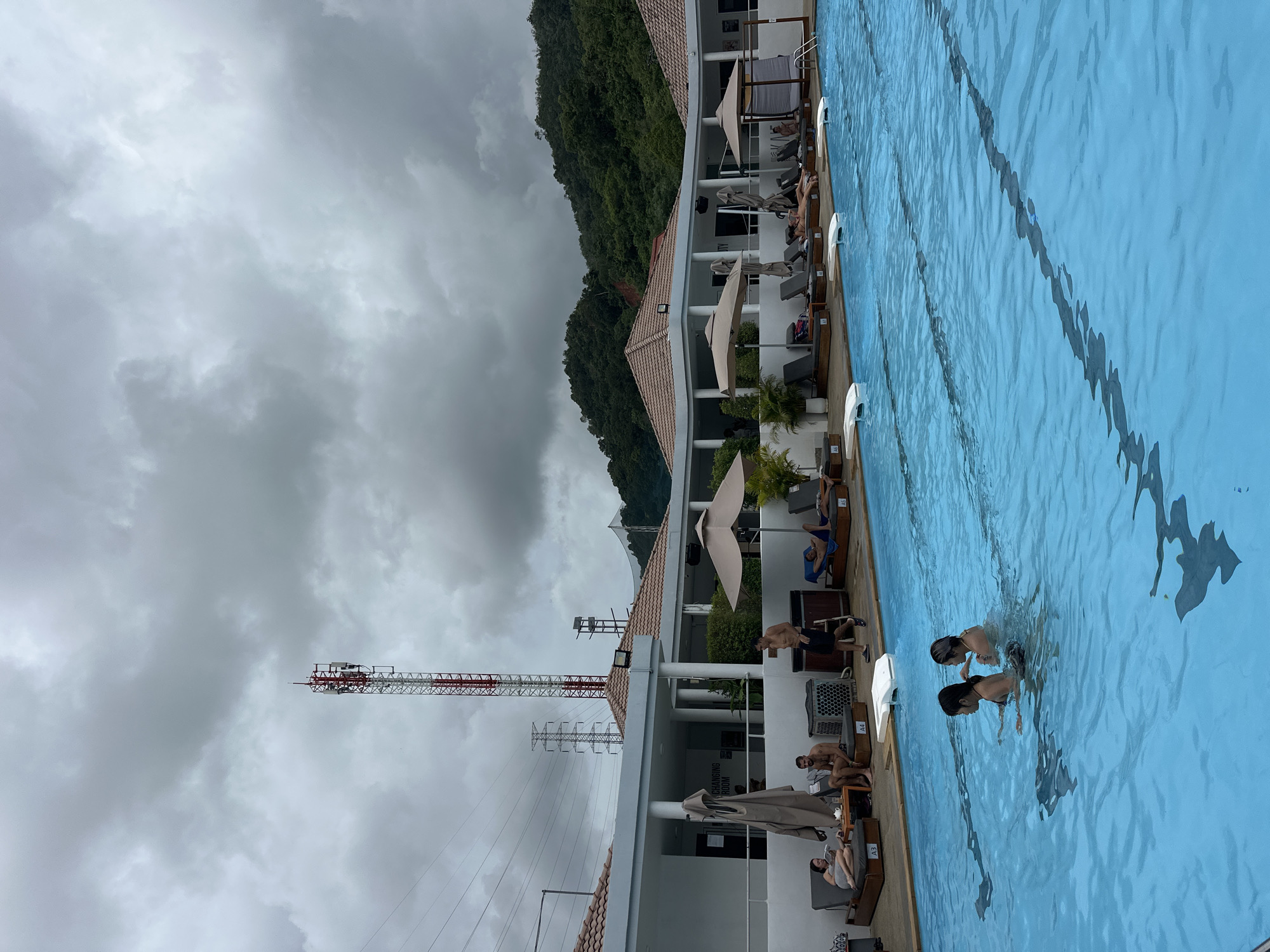 Poolside afternoon at a Kathu resort with DJ and overcast skies