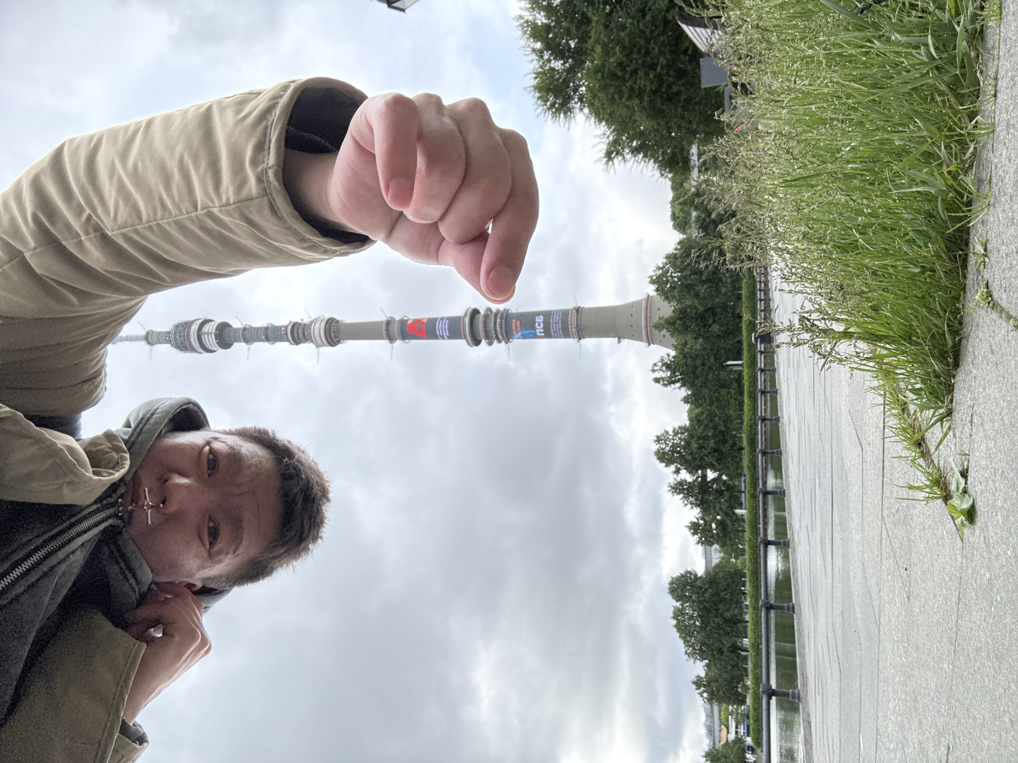 Tourist photographs Ostankino Tower area during early morning visit