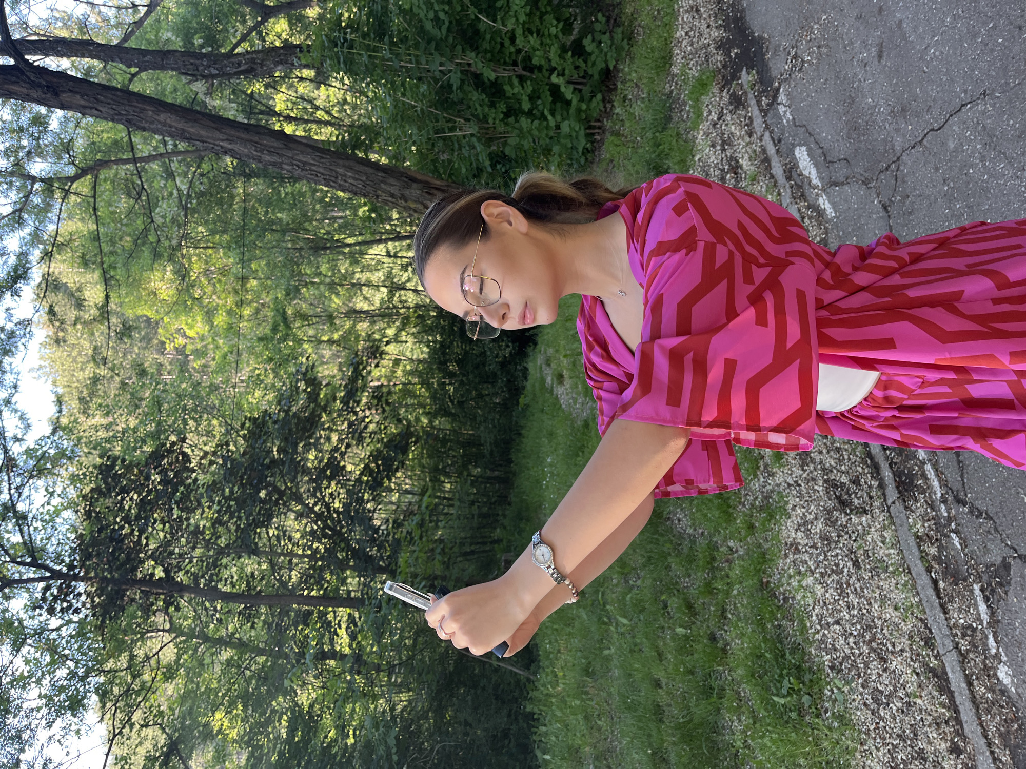 Woman photographs ducks at Blagoevgrad park pond