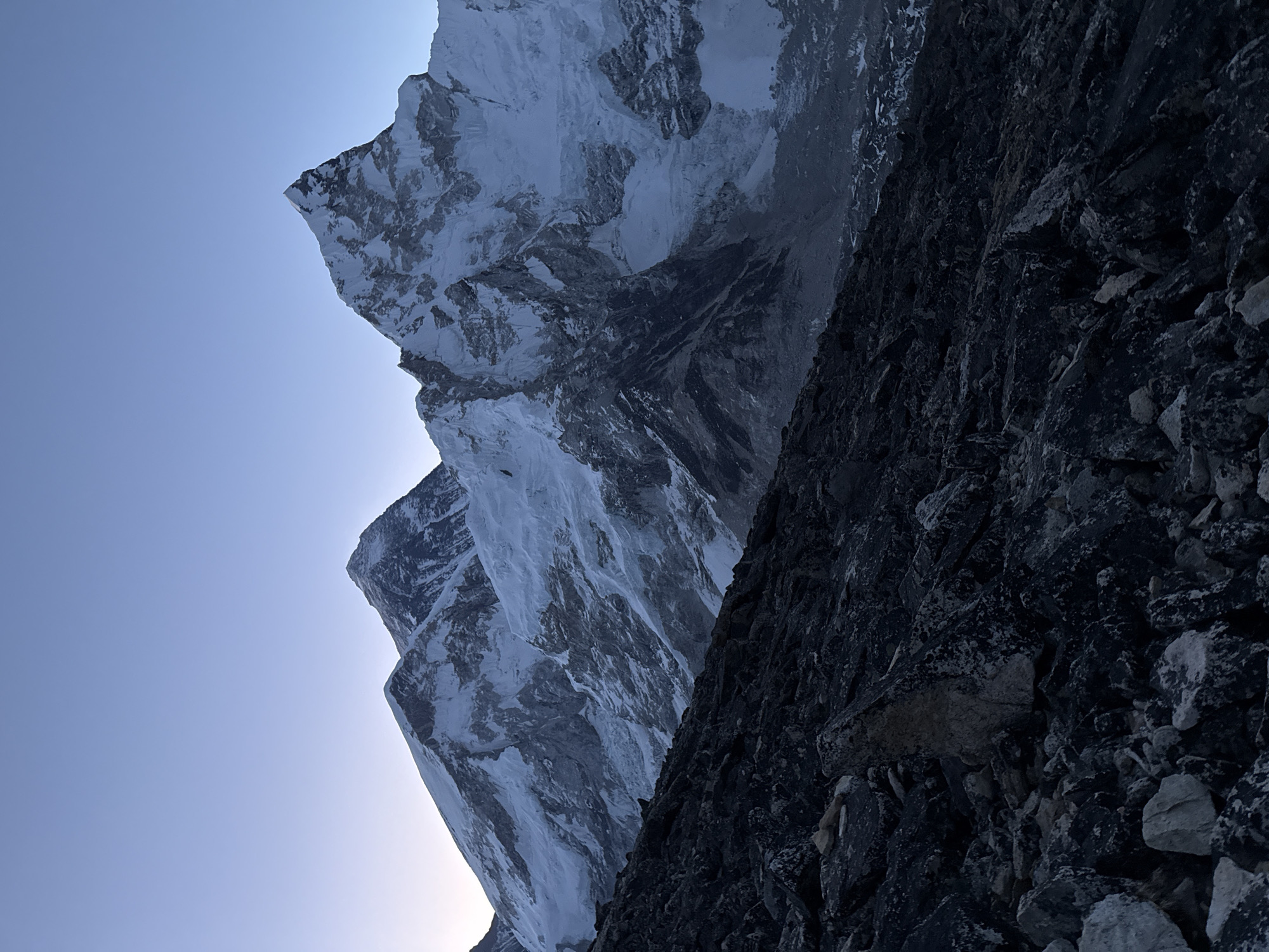 Hikers trek rocky Himalayan paths near Khumjung at dawn