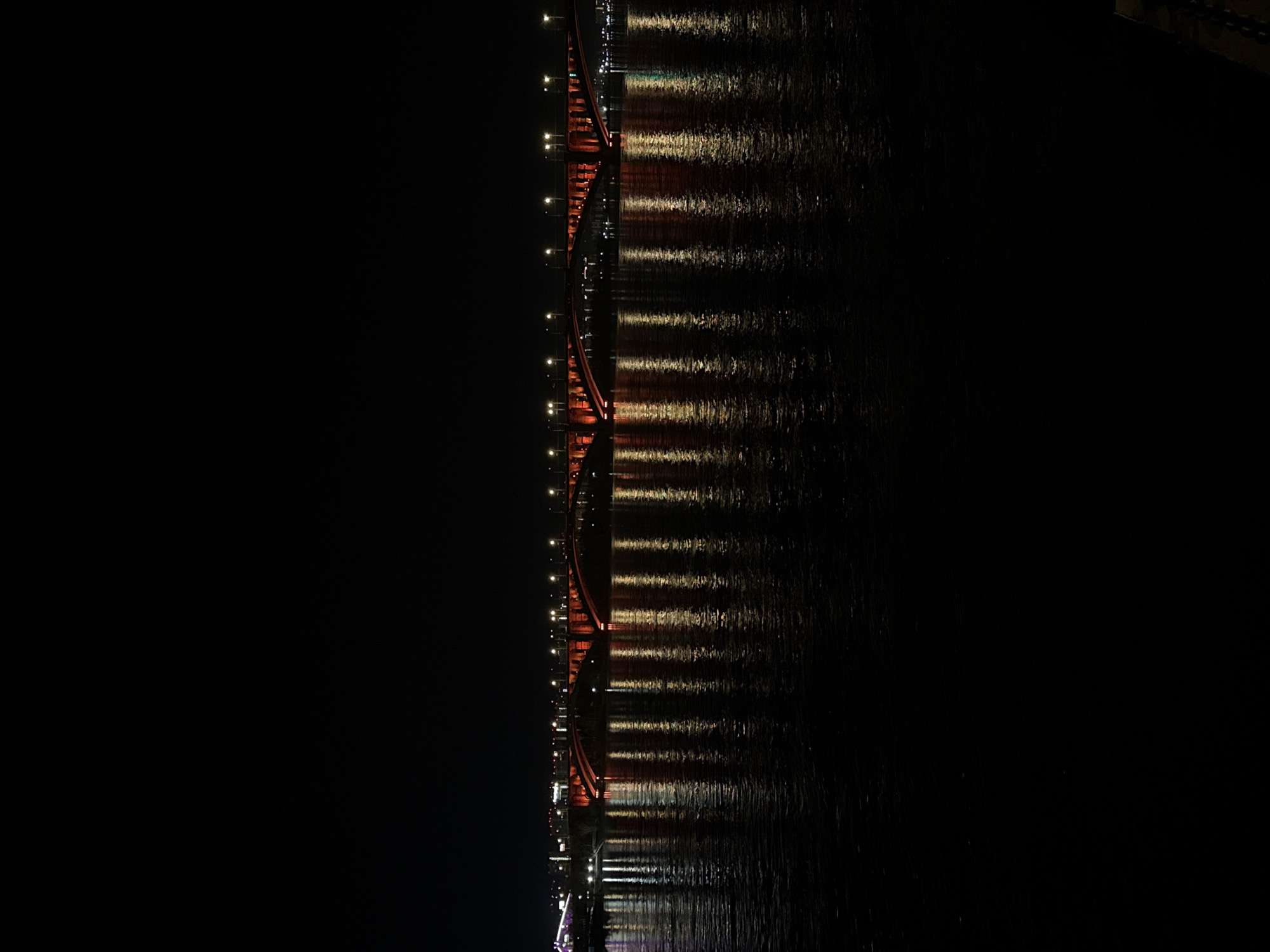 Red bridge photographed at night in Krasnoyarsk, Russia