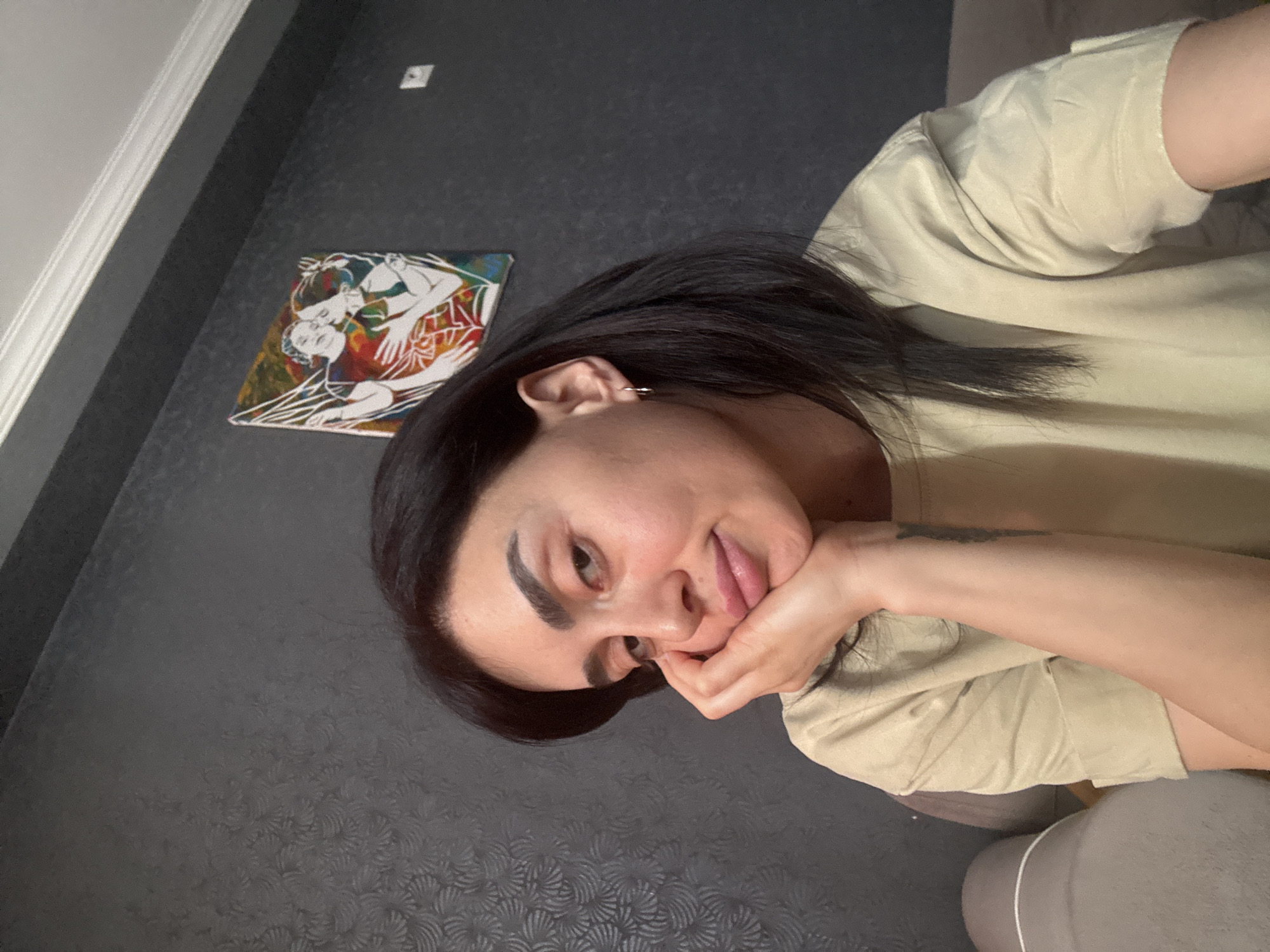 Woman poses for photos on couch in Tbilisi home