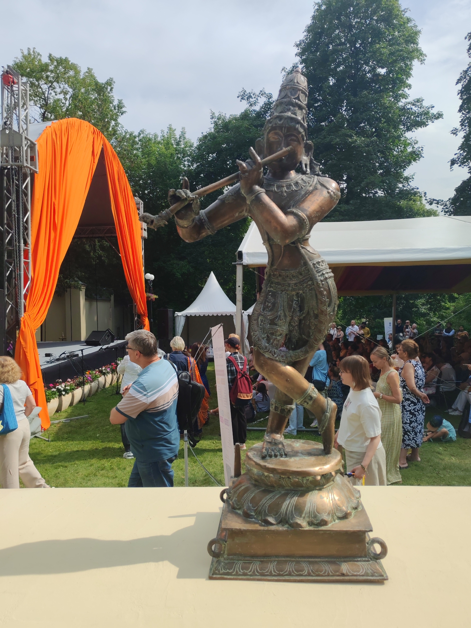 Hindu statues, traditional attire, and cultural decor at an outdoor event