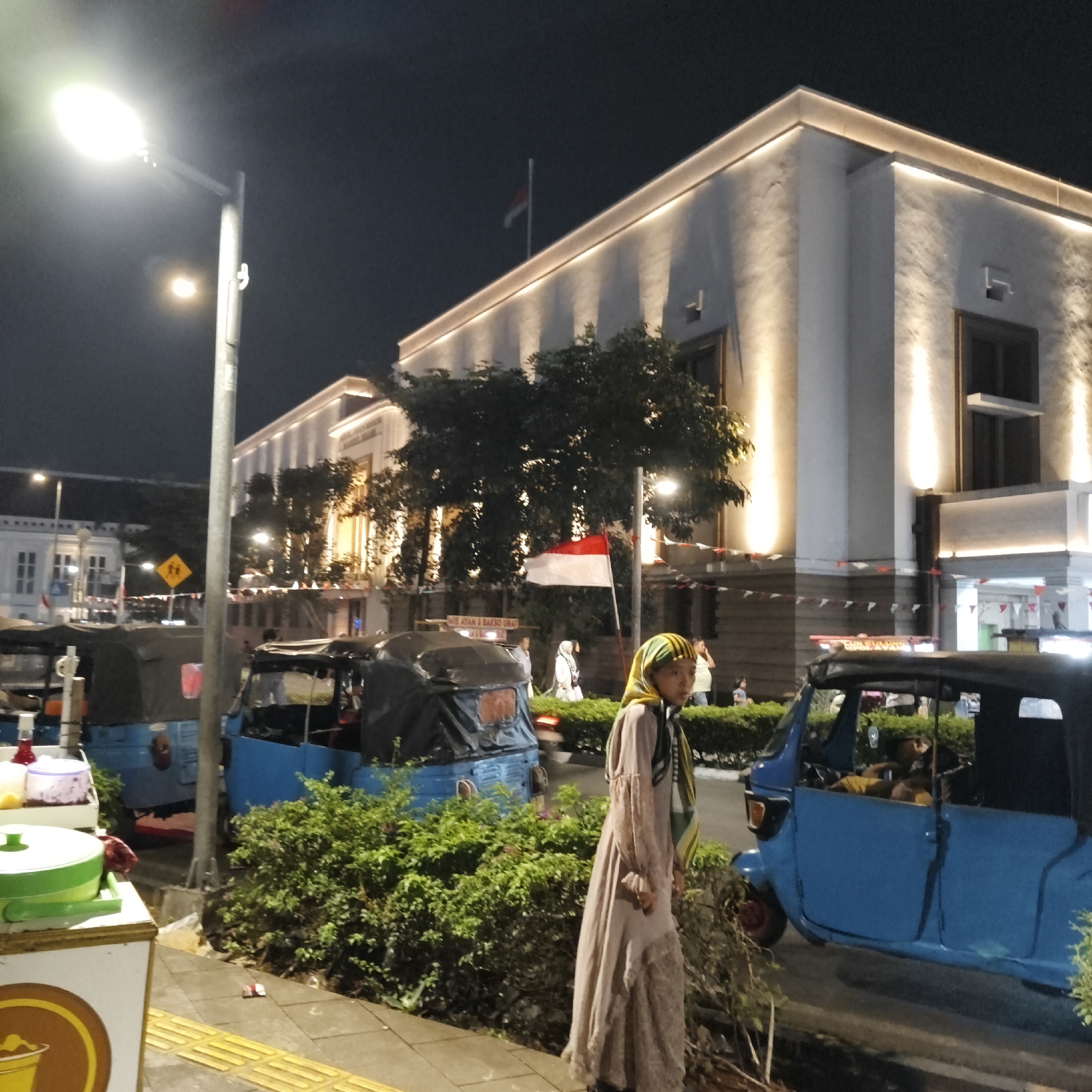West Jakarta street life after dark, food stalls to landmarks