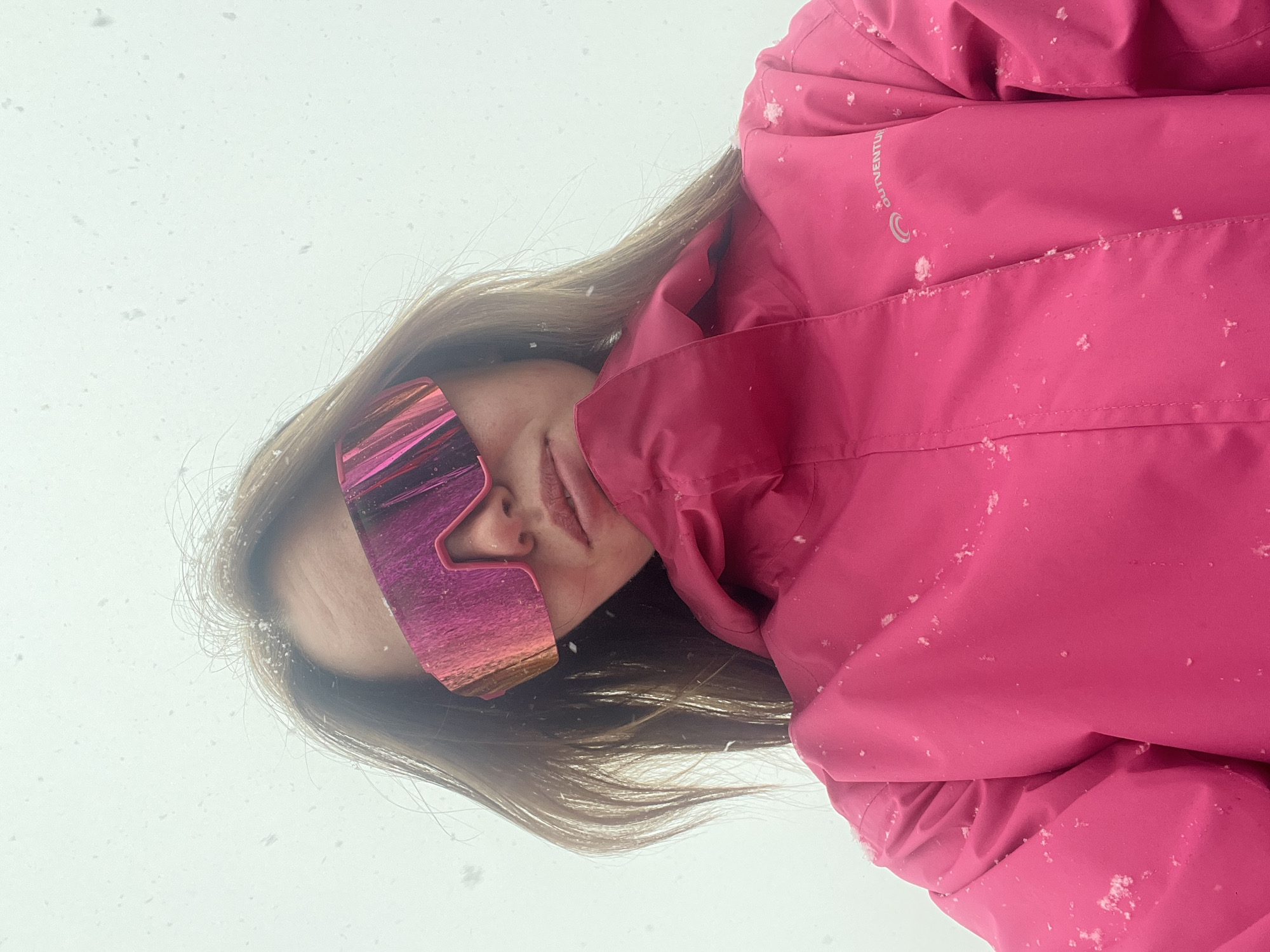 Skier takes selfie in pink gear amid snowfall in Kliuchi