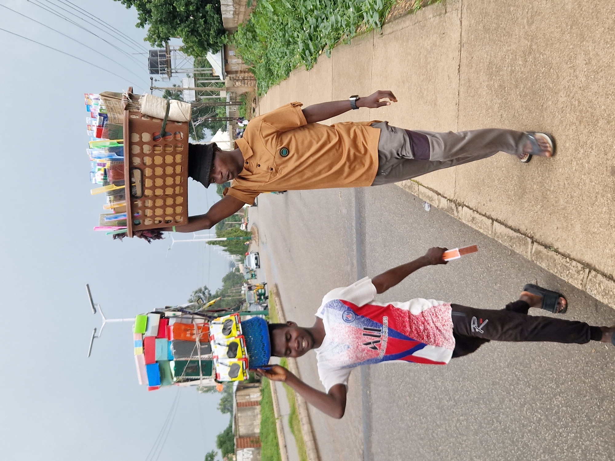 Foot traffic and street vendors along a Jos, Nigeria roadside
