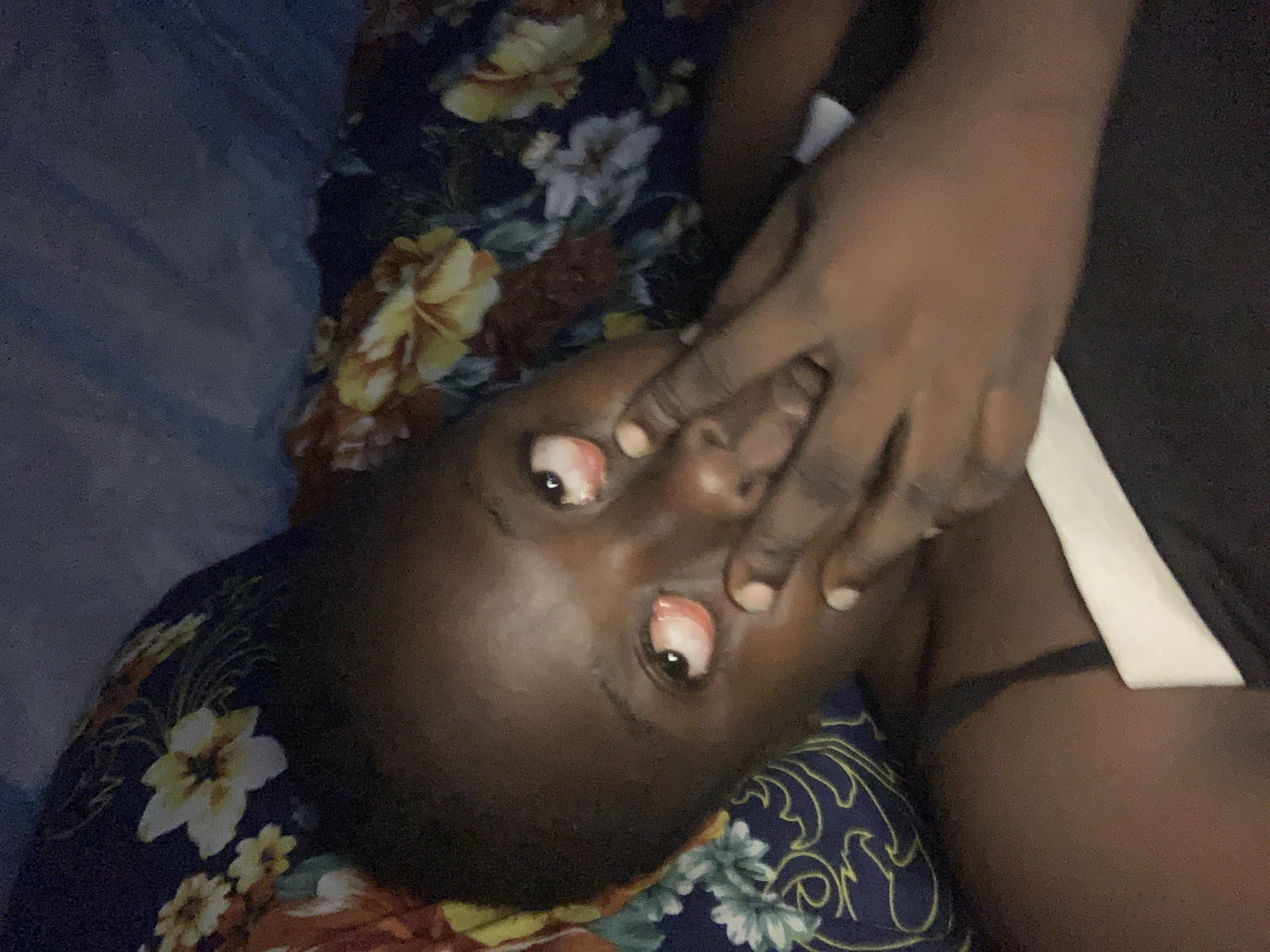 Person resting on floral fabric observed in Kukum, Nigeria