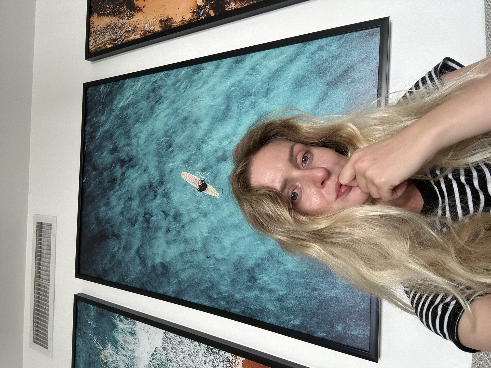 Woman photographed near artwork, skincare products in Petah Tikva