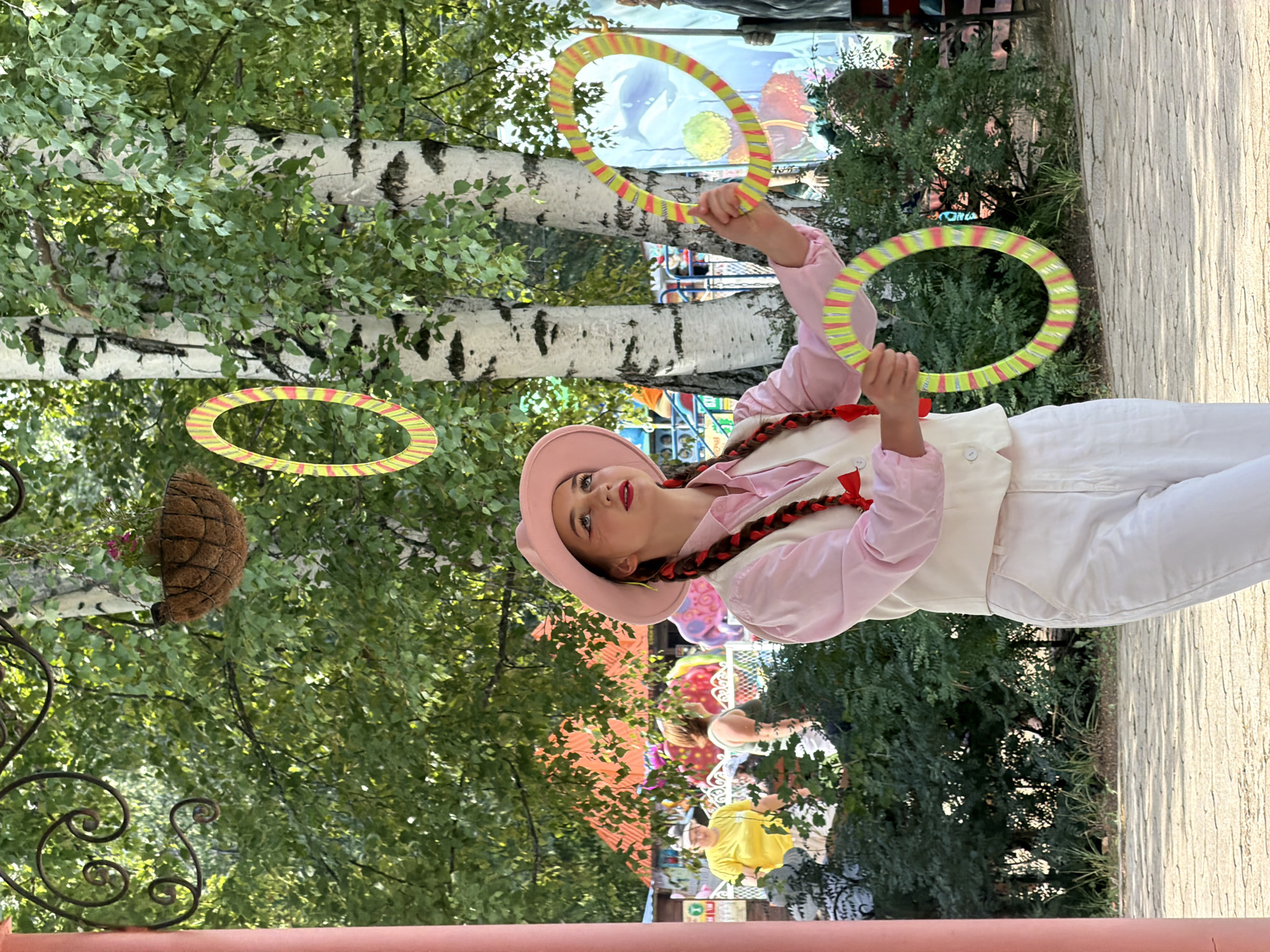 Circus performer juggles, unicycles, and entertains kids in Chaikovsky park