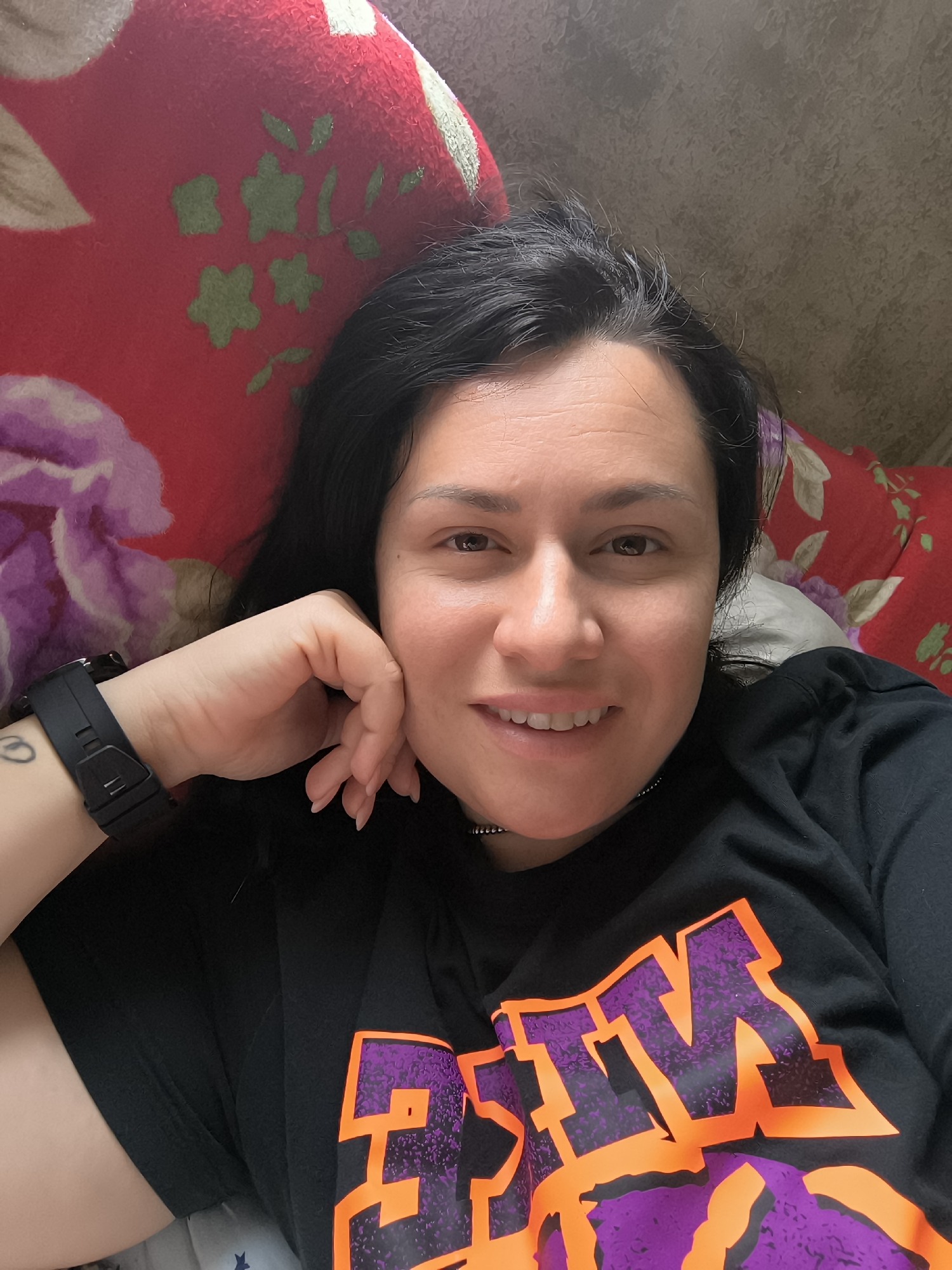 Woman takes selfie on floral pillow in Pleven