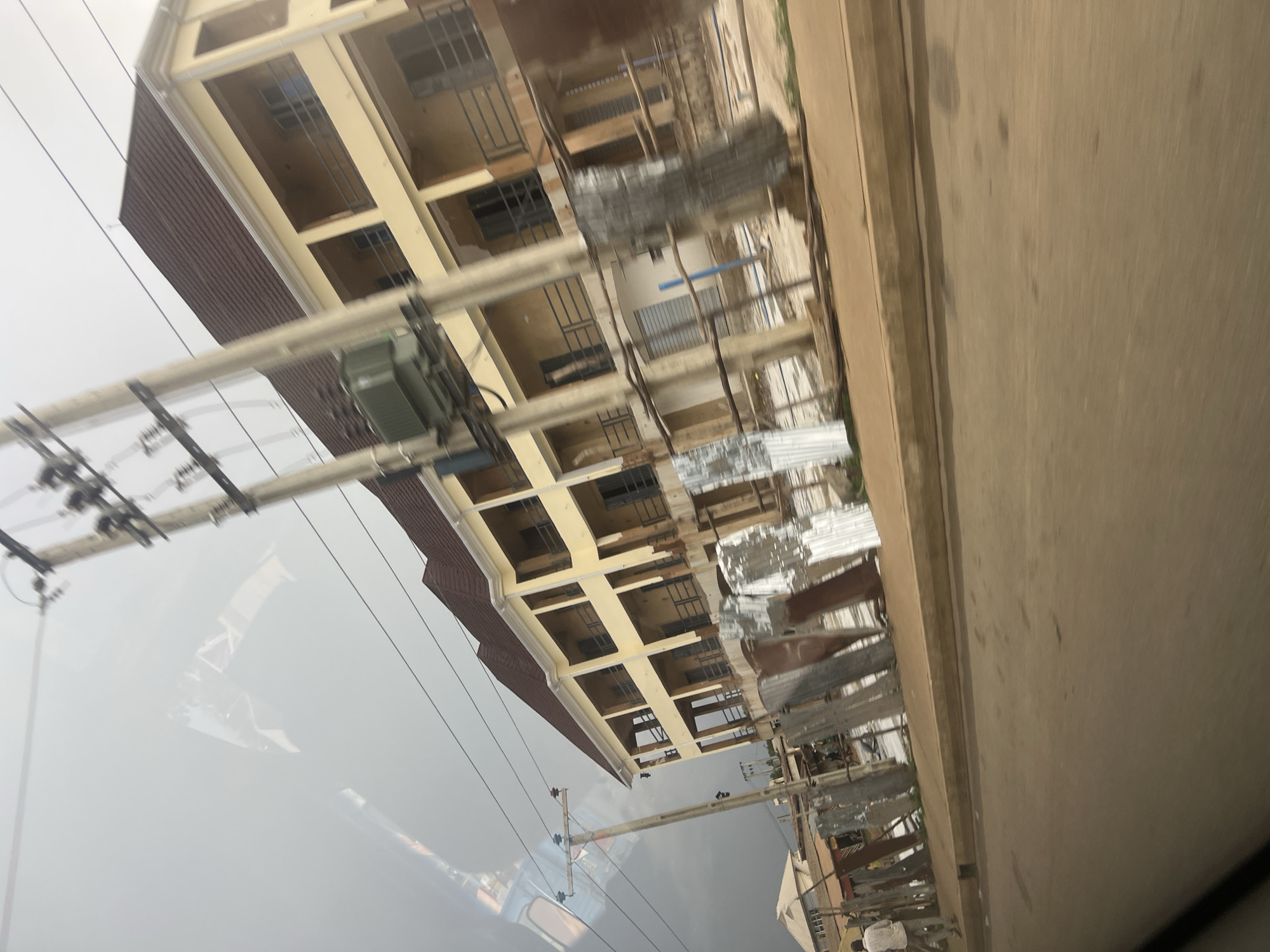 Yellow multi-story building mid-construction in Bukuru, Nigeria