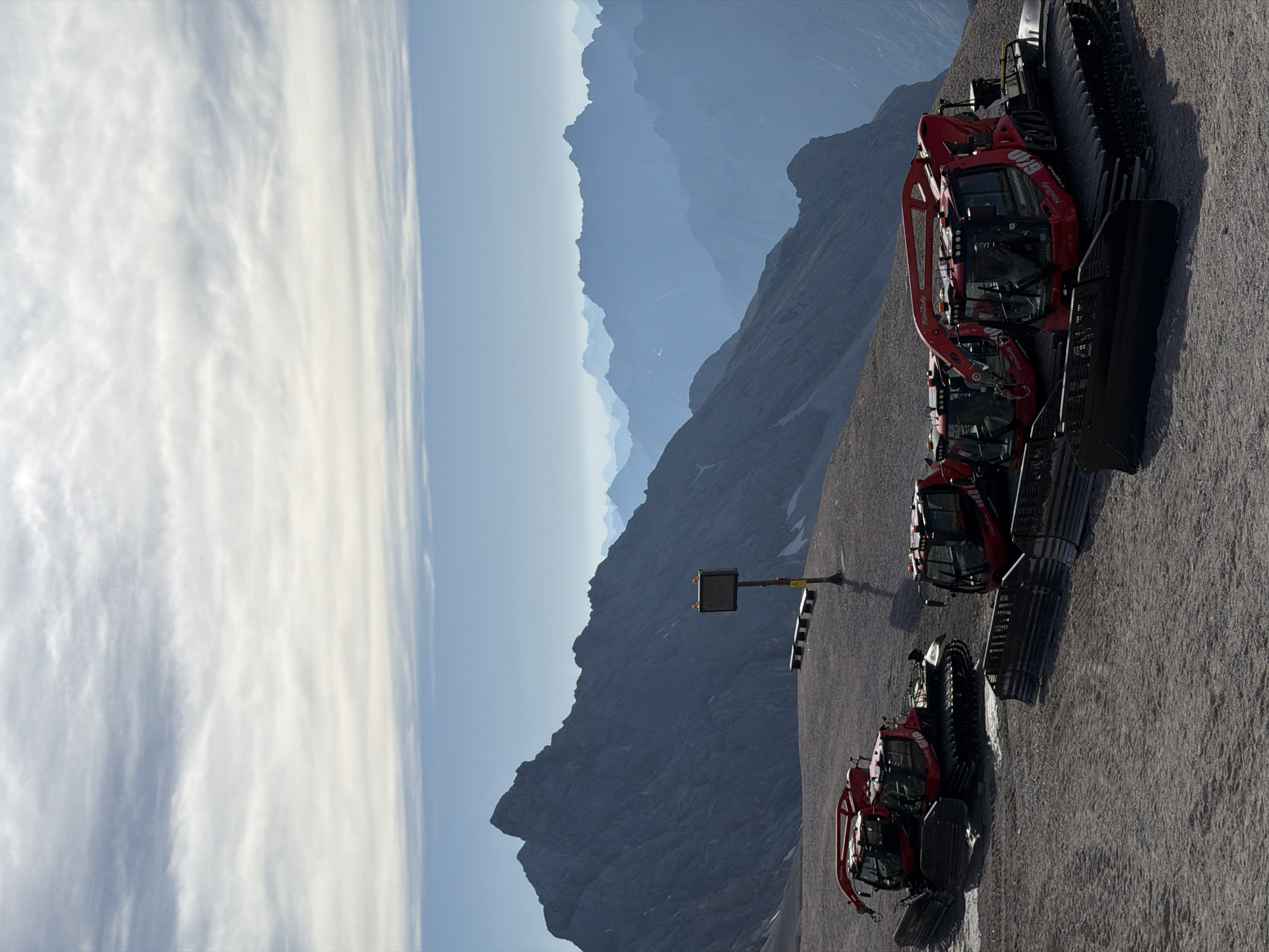 Red snow groomers parked on a mountain slope in Garmisch-Partenkirchen