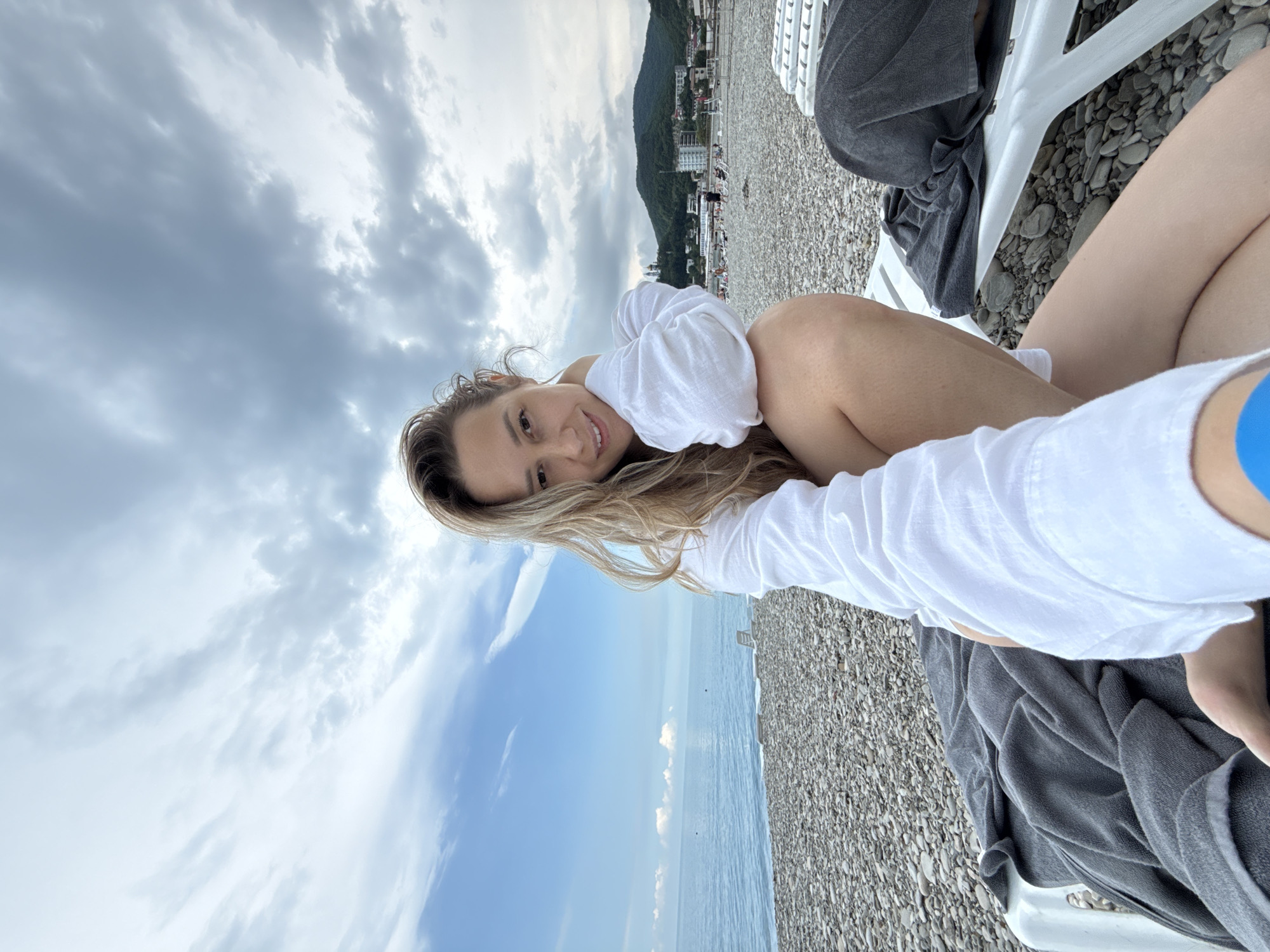 Woman photographs beach visit in Nebug, Russia