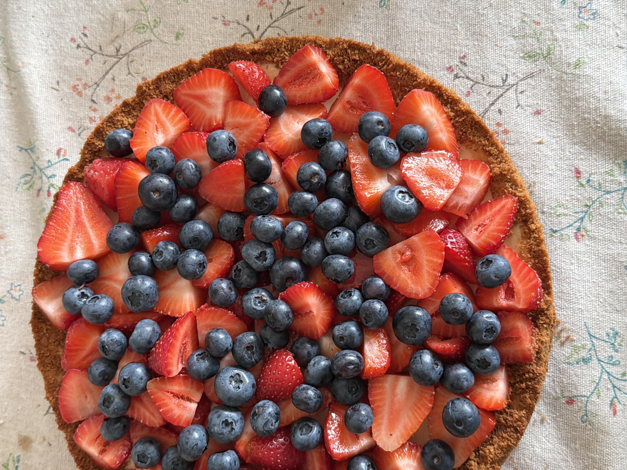Strawberry and blueberry tart on a white tablecloth in Kazan