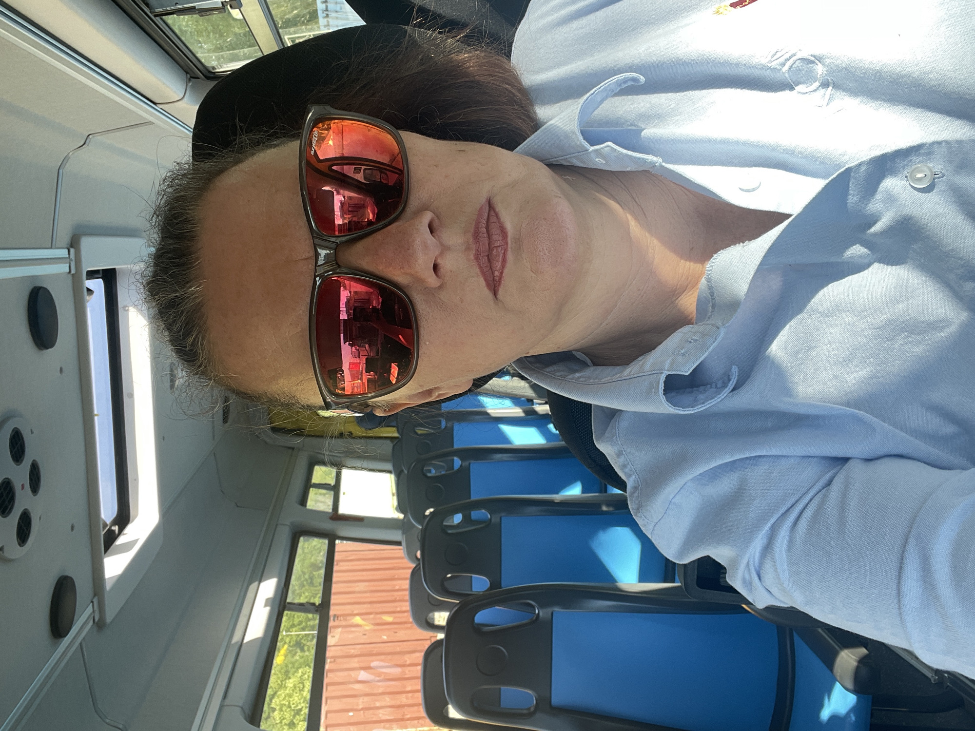 Woman in sunglasses rides morning bus in Rome
